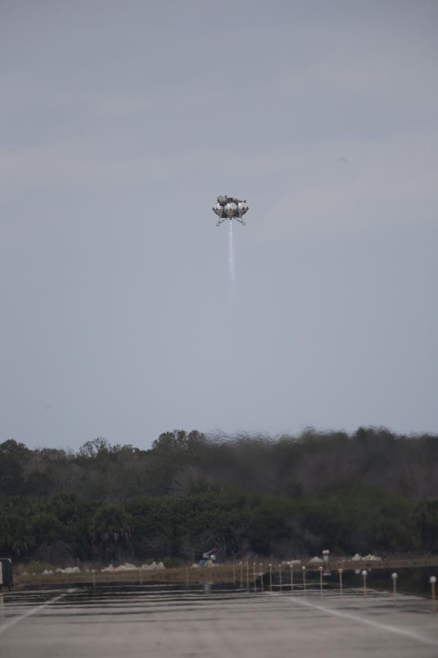 CAPE CANAVERAL, Fla. – The Project Morpheus prototype lander soars high after launching on its fourth free flight test at the north end of the Shuttle Landing Facility at NASA’s Kennedy Space Center in Florida. The 64-second test began at 1:15 p.m. EST with the Morpheus lander launching from the ground over a flame trench and ascending about 305 feet, significantly increasing the ascent velocity from the last test. The lander flew forward, covering about 358 feet in 25 seconds before descending and landing within 15 inches of its target on a dedicated pad inside the autonomous landing and hazard avoidance technology, or ALHAT, hazard field. Project Morpheus tests NASA’s ALHAT and an engine that runs on liquid oxygen and methane, or green propellants, into a fully-operational lander that could deliver cargo to other planetary surfaces. The landing facility provides the lander with the kind of field necessary for realistic testing, complete with rocks, craters and hazards to avoid. Morpheus’ ALHAT payload allows it to navigate to clear landing sites amidst rocks, craters and other hazards during its descent. Project Morpheus is being managed under the Advanced Exploration Systems, or AES, Division in NASA’s Human Exploration and Operations Mission Directorate. The efforts in AES pioneer new approaches for rapidly developing prototype systems, demonstrating key capabilities and validating operational concepts for future human missions beyond Earth orbit. For more information on Project Morpheus, visit http://www.nasa.gov/centers/johnson/exploration/morpheus. Photo credit: NASA/Kim Shiflett