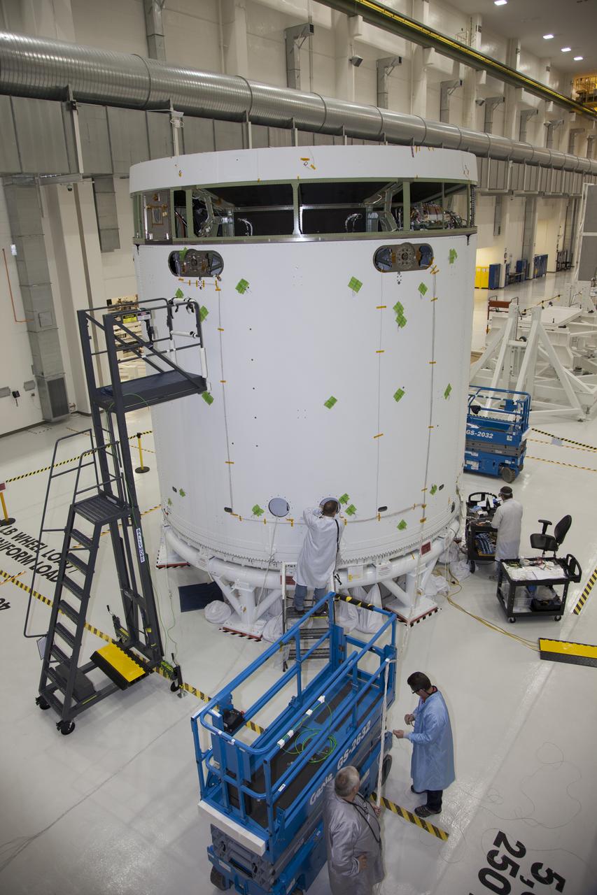CAPE CANAVERAL, Fla. – Inside the Operations and Checkout Building high bay at NASA’s Kennedy Space Center in Florida, technicians complete the installation of the fairings on the service module for the Orion spacecraft. The fairings will protect the service module during launch. The Orion spacecraft is being prepared for its first unpiloted flight test, Exploration Flight Test-1, or EFT-1, scheduled for launch atop a Delta IV rocket in September 2014. The Orion spacecraft is designed to carry astronauts to destinations not yet explored by humans. It will have emergency abort capability, sustain the crew during space travel and provide safe re-entry from deep space return velocities. Orion is scheduled to launch atop NASA’s Space Launch System rocket in 2017. For more information, visit http://www.nasa.gov/orion. Photo credit: NASA/Daniel Casper