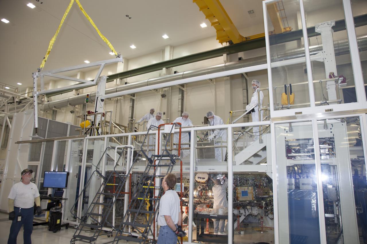 CAPE CANAVERAL, Fla. – Inside the Operations and Checkout Building high bay at NASA’s Kennedy Space Center in Florida, engineers work on the Orion crew module inside a temporary clean room. Welding on the crew module was completed this month. The Orion spacecraft is being prepared for its first unpiloted flight test, Exploration Flight Test-1, or EFT-1, scheduled for launch atop a Delta IV rocket in September 2014. The Orion spacecraft is designed to carry astronauts to destinations not yet explored by humans. It will have emergency abort capability, sustain the crew during space travel and provide safe re-entry from deep space return velocities. Orion is scheduled to launch atop NASA’s Space Launch System rocket in 2017. For more information, visit http://www.nasa.gov/orion. Photo credit: NASA/Daniel Casper
