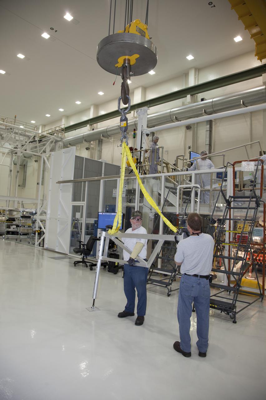 CAPE CANAVERAL, Fla. – Inside the Operations and Checkout Building high bay at NASA’s Kennedy Space Center in Florida, engineers work on the Orion crew module inside a temporary clean room. Welding on the crew module was completed this month. The Orion spacecraft is being prepared for its first unpiloted flight test, Exploration Flight Test-1, or EFT-1, scheduled for launch atop a Delta IV rocket in September 2014. The Orion spacecraft is designed to carry astronauts to destinations not yet explored by humans. It will have emergency abort capability, sustain the crew during space travel and provide safe re-entry from deep space return velocities. Orion is scheduled to launch atop NASA’s Space Launch System rocket in 2017. For more information, visit http://www.nasa.gov/orion. Photo credit: NASA/Daniel Casper