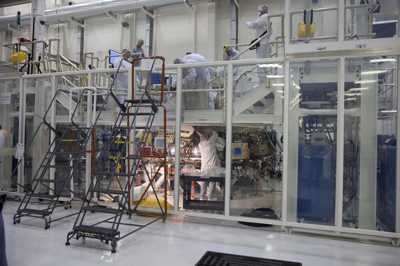 CAPE CANAVERAL, Fla. – Inside the Operations and Checkout Building high bay at NASA’s Kennedy Space Center in Florida, engineers work on the Orion crew module inside a temporary clean room. Welding on the crew module was completed this month. The Orion spacecraft is being prepared for its first unpiloted flight test, Exploration Flight Test-1, or EFT-1, scheduled for launch atop a Delta IV rocket in September 2014. The Orion spacecraft is designed to carry astronauts to destinations not yet explored by humans. It will have emergency abort capability, sustain the crew during space travel and provide safe re-entry from deep space return velocities. Orion is scheduled to launch atop NASA’s Space Launch System rocket in 2017. For more information, visit http://www.nasa.gov/orion. Photo credit: NASA/Daniel Casper