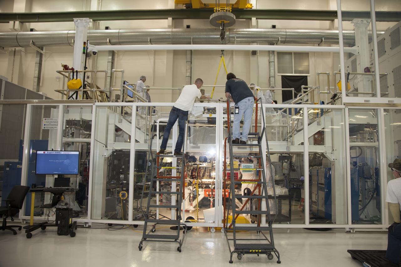 CAPE CANAVERAL, Fla. – Inside the Operations and Checkout Building high bay at NASA’s Kennedy Space Center in Florida, engineers work on the Orion crew module inside a temporary clean room. Welding on the crew module was completed this month. The Orion spacecraft is being prepared for its first unpiloted flight test, Exploration Flight Test-1, or EFT-1, scheduled for launch atop a Delta IV rocket in September 2014. The Orion spacecraft is designed to carry astronauts to destinations not yet explored by humans. It will have emergency abort capability, sustain the crew during space travel and provide safe re-entry from deep space return velocities. Orion is scheduled to launch atop NASA’s Space Launch System rocket in 2017. For more information, visit http://www.nasa.gov/orion. Photo credit: NASA/Daniel Casper