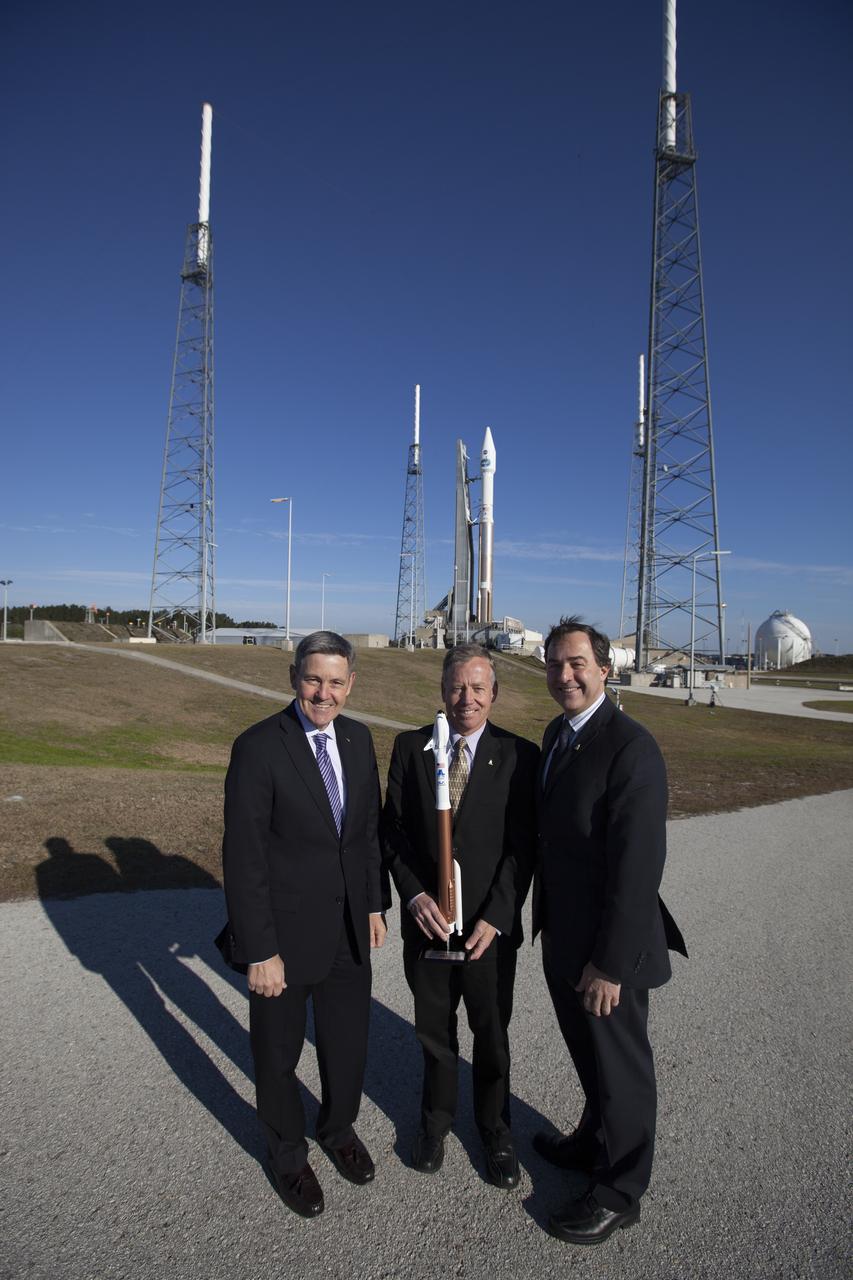 CAPE CANAVERAL, Fla. – NASA and aerospace industry representatives tour facilities along Florida’s Space Coast prior to announcements made by Sierra Nevada Corporation, or SNC, Space Systems, to prepare for a November 2016 orbital flight of its Dream Chaser spacecraft. Posing for a photo in front of a United Launch Alliance, or ULA, Atlas V rocket are, from left, Bob Cabana, director of NASA’s Kennedy Space Center Steve Lindsey, Dream Chaser program manager for SNC Space Systems and Mark Sirangelo, corporate vice president and head of SNC Space Systems. The announcements made during a news conference at Kennedy are considered substantial for SNC and important to plans by NASA and Space Florida for Kennedy’s transformation into a multi-user spaceport for both commercial and government customers. SNC announced it plans to work with ULA to launch the Dream Chaser spacecraft into orbit atop an Atlas V rocket from Space Launch Complex 41 at Cape Canaveral Air Force Station intends to land the winged spacecraft at the 3.5-mile-long runway at Kennedy’s Shuttle Landing Facility lease office space at Exploration Park, right outside Kennedy’s gates and process the spacecraft in the high bay of the Operations and Checkout Building at Kennedy, with Lockheed Martin performing the work. Photo credit: NASA/Cory Huston  