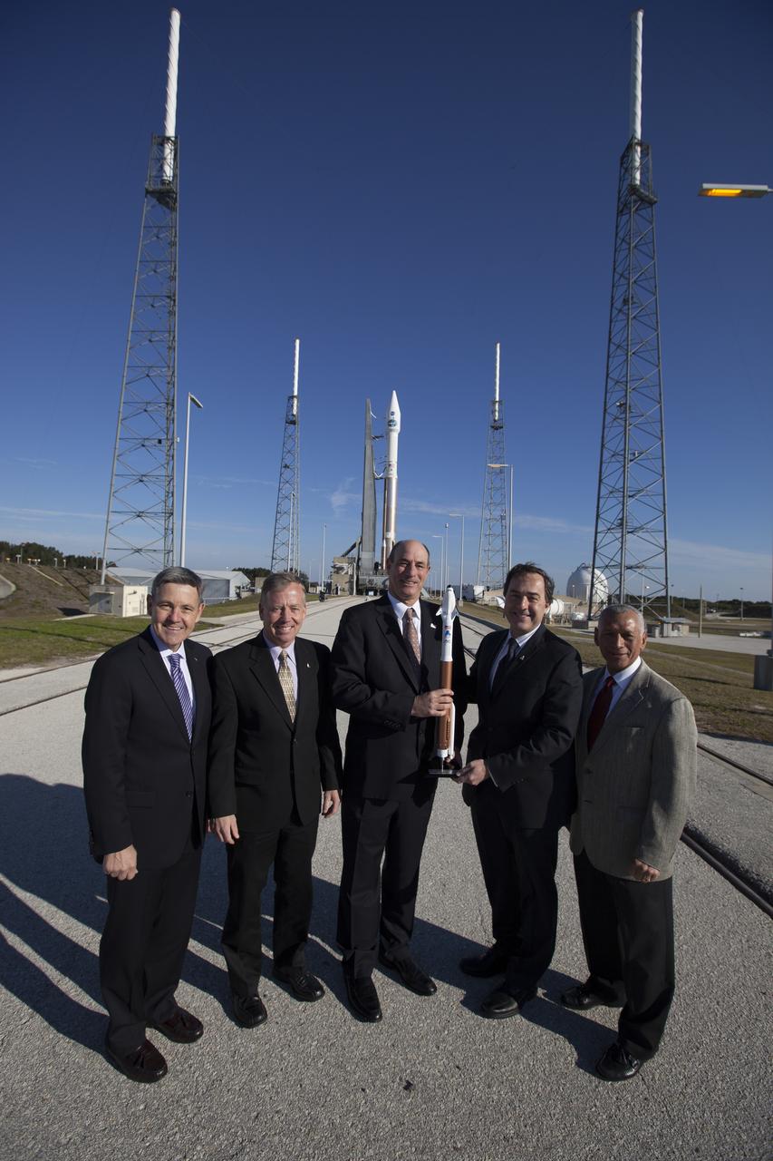 CAPE CANAVERAL, Fla. – NASA and aerospace industry representatives tour facilities along Florida’s Space Coast prior to announcements made by Sierra Nevada Corporation, or SNC, Space Systems, to prepare for a November 2016 orbital flight of its Dream Chaser spacecraft. Posing for a photo in front of a United Launch Alliance, or ULA, Atlas V rocket are, from left, Bob Cabana, director of NASA’s Kennedy Space Center Steve Lindsey, Dream Chaser program manager for SNC Space Systems Michael Gass, president and CEO of United Launch Alliance, or ULA Mark Sirangelo, corporate vice president and head of SNC Space Systems and Charlie Bolden, administrator of NASA. The announcements made during a news conference at Kennedy are considered substantial for SNC and important to plans by NASA and Space Florida for Kennedy’s transformation into a multi-user spaceport for both commercial and government customers. SNC announced it plans to work with ULA to launch the Dream Chaser spacecraft into orbit atop an Atlas V rocket from Space Launch Complex 41 at Cape Canaveral Air Force Station intends to land the winged spacecraft at the 3.5-mile-long runway at Kennedy’s Shuttle Landing Facility lease office space at Exploration Park, right outside Kennedy’s gates and process the spacecraft in the high bay of the Operations and Checkout Building at Kennedy, with Lockheed Martin performing the work. Photo credit: NASA/Cory Huston