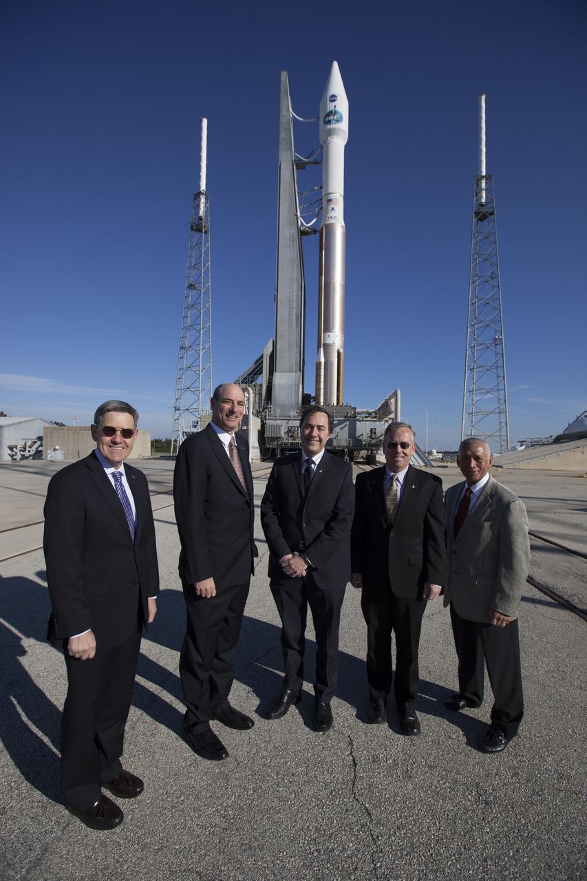 CAPE CANAVERAL, Fla. – NASA and aerospace industry representatives tour facilities along Florida’s Space Coast prior to announcements made by Sierra Nevada Corporation, or SNC, Space Systems, to prepare for a November 2016 orbital flight of its Dream Chaser spacecraft. Posing for a photo in front of a United Launch Alliance, or ULA, Atlas V rocket are, from left, Bob Cabana, director of NASA’s Kennedy Space Center Michael Gass, president and CEO of United Launch Alliance, or ULA Mark Sirangelo, corporate vice president and head of SNC Space Systems Steve Lindsey, Dream Chaser program manager for SNC Space Systems and Charlie Bolden, administrator of NASA. The announcements made during a news conference at Kennedy are considered substantial for SNC and important to plans by NASA and Space Florida for Kennedy’s transformation into a multi-user spaceport for both commercial and government customers. SNC announced it plans to work with ULA to launch the Dream Chaser spacecraft into orbit atop an Atlas V rocket from Space Launch Complex 41 at Cape Canaveral Air Force Station intends to land the winged spacecraft at the 3.5-mile-long runway at Kennedy’s Shuttle Landing Facility lease office space at Exploration Park, right outside Kennedy’s gates and process the spacecraft in the high bay of the Operations and Checkout Building at Kennedy, with Lockheed Martin performing the work. Photo credit: NASA/Cory Huston