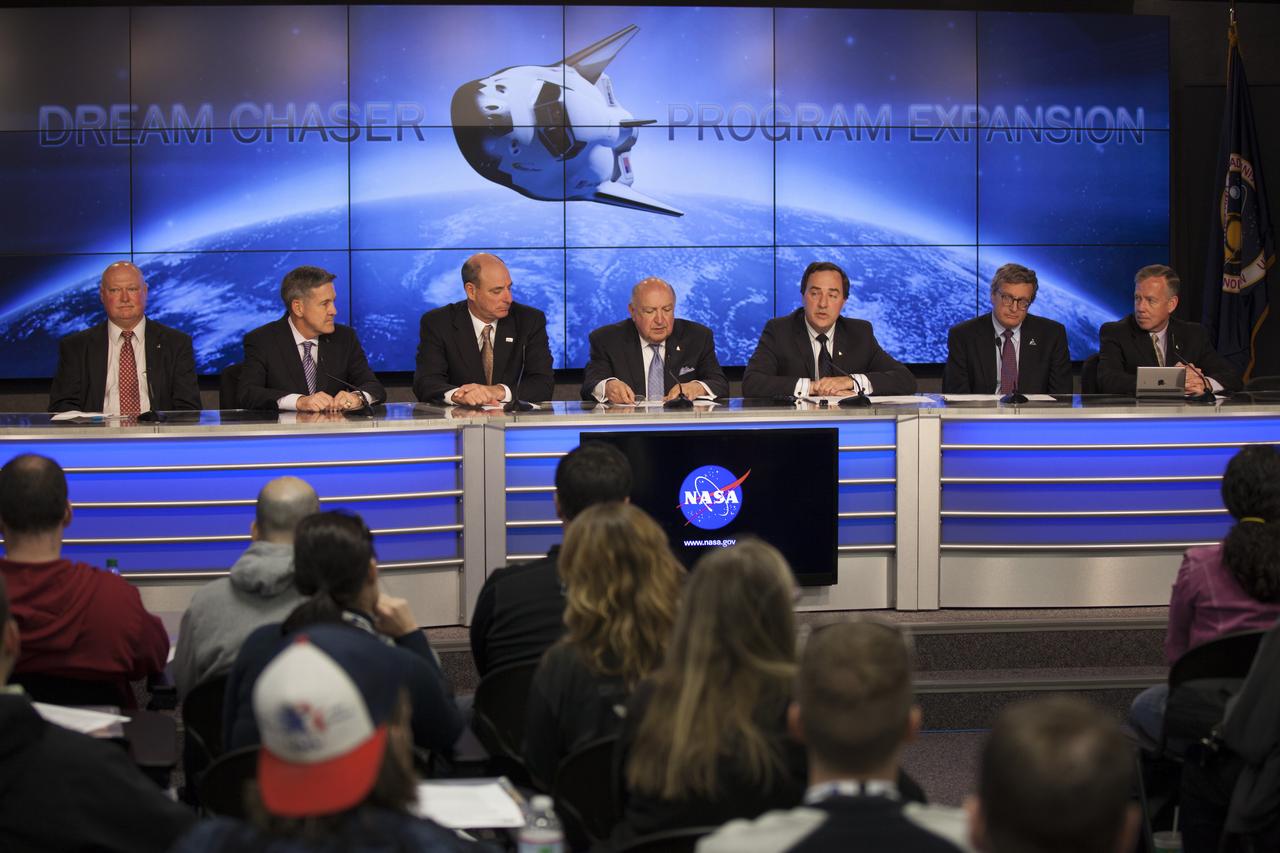 CAPE CANAVERAL, Fla. – Sierra Nevada Corporation, or SNC, Space Systems, announces the steps the company will take to prepare for a November 2016 orbital flight of its Dream Chaser spacecraft from Florida’s Space Coast during a news conference at NASA’s Kennedy Space Center in Florida. Participants are, from left, Michael Curie, NASA spokesman, Bob Cabana, director of Kennedy, Michael Gass, president and CEO of United Launch Alliance, or ULA, Frank DiBello, president and CEO of Space Florida, Mark Sirangelo, corporate vice president and head of SNC Space Systems, Larry Price, Lockheed Martin Space Systems deputy program manager for NASA's Orion spacecraft, and Steve Lindsey, Dream Chaser program manager for SNC Space Systems. The steps are considered substantial for SNC and important to plans by NASA and Space Florida for Kennedy’s transformation into a multi-user spaceport for both commercial and government customers. SNC said it plans to work with ULA to launch the Dream Chaser spacecraft into orbit atop an Atlas V rocket from Space Launch Complex 41 at Cape Canaveral Air Force Station intends to land the winged spacecraft at Kennedy’s 3.5-mile long runway at the Shuttle Landing Facility lease office space at Exploration Park, right outside Kennedy’s gates and process the spacecraft in the high bay of the Operations and Checkout Building at Kennedy, with Lockheed Martin performing the work. Photo credit: NASA/Kim Shiflett
