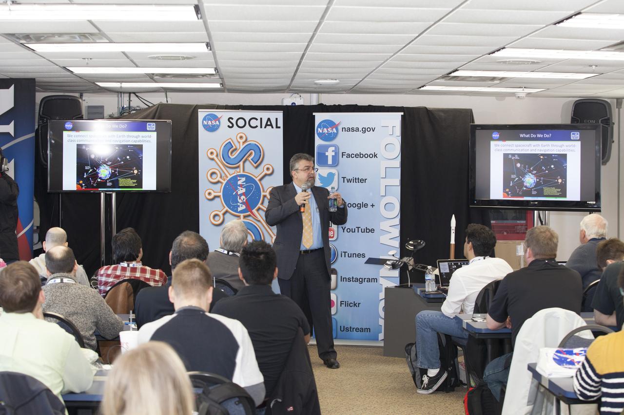 CAPE CANAVERAL, Fla. -- In the NASA News Center annex at NASA's Kennedy Space Center in Florida, social media participants listen to a briefing by Badri Younes, deputy associate administrator, Space Communications and Navigation SCaN NASA Human Exploration and Operations Mission Directorate at NASA Headquarters in Washington D.C. The social media participants gathered at the Florida spaceport for the launch of the Tracking and Data Relay Satellite, or TDRS-L spacecraft. Their visit included tours of key facilities and participating in presentations by key NASA leaders who updated the space agency's current efforts. Photo credit: NASA/Dan Casper