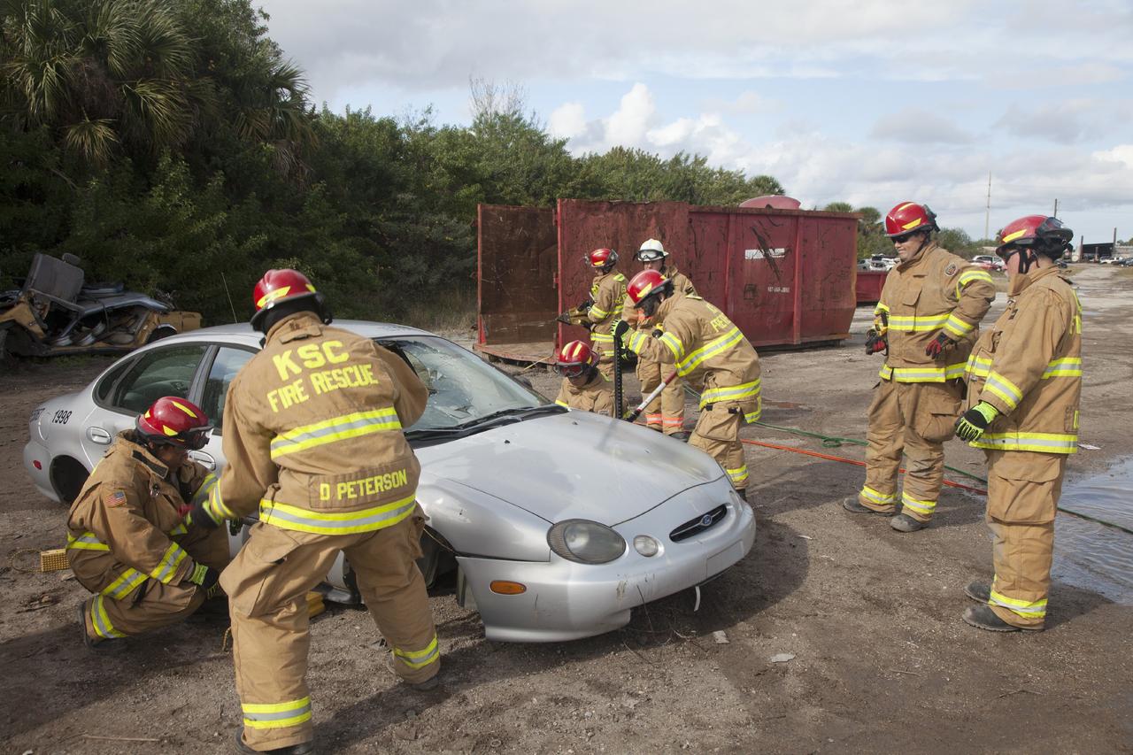 CAPE CANAVERAL, Fla. – Special Rescue Operations firefighters with NASA Fire Rescue Services in the Protective Services Office at NASA’s Kennedy Space Center in Florida practice vehicle extrication training at an auto salvage yard near the center. The firefighters used the Jaws of Life on the vehicle to simulate the rescue of a trapped and injured person. Other equipment used includes axes, tools to punch through and clear away the windshield and windows and a hydraulic cutting tool that is used to remove the roof of a car.    Kennedy’s firefighters recently achieved Pro Board Certification in aerial fire truck operations. With the completion of vehicle extrication and Jaws of Life training, the Protective Services Office is one step closer to achieving certification in vehicle machinery extrication. Kennedy’s firefighters are with G4S Government Solutions Inc., on the Kennedy Protective Services Contract. Photo credit: NASA/Daniel Casper