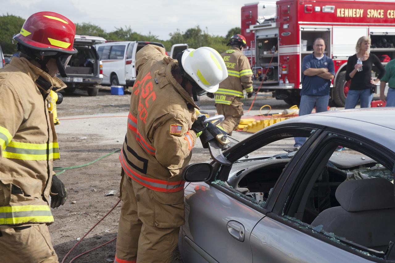 CAPE CANAVERAL, Fla. – Special Rescue Operations firefighters with NASA Fire Rescue Services in the Protective Services Office at NASA’s Kennedy Space Center in Florida practice vehicle extrication training at an auto salvage yard near the center. A firefighter uses a special hydraulic tool to cut through the vehicle in order to remove the roof.  They will use the Jaws of Life on the vehicle to simulate the rescue of a trapped and injured person. Other rescue equipment includes axes and tools to punch through and clear away windshields and windows.     Kennedy’s firefighters recently achieved Pro Board Certification in aerial fire truck operations. With the completion of vehicle extrication and Jaws of Life training, the Protective Services Office is one step closer to achieving certification in vehicle machinery extrication. Kennedy’s firefighters are with G4S Government Solutions Inc., on the Kennedy Protective Services Contract. Photo credit: NASA/Daniel Casper