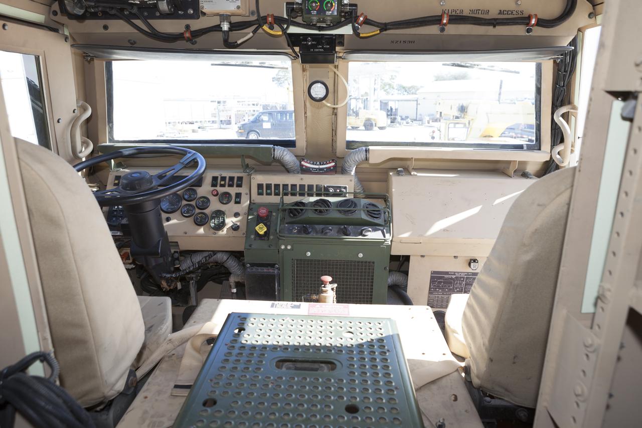 CAPE CANAVERAL, Fla. – A view of the interior of one of four new emergency egress vehicles, called Mine-Resistant Ambush-Protected, or MRAP, vehicles is shown. The MRAPs are at the Maintenance and Operations Facility at NASA’s Kennedy Space Center in Florida. The MRAPs arrived from the U.S. Army Red River Depot in Texarkana, Texas in December 2013. The vehicles were processed in and then transported to the Rotation, Processing and Surge Facility near the Vehicle Assembly Building for temporary storage. The Ground Systems Development and Operations Program at Kennedy led the efforts to an emergency egress vehicle that future astronauts could quickly use to leave the Launch Complex 39 area in case of an emergency. During crewed launches of NASA’s Space Launch System and Orion spacecraft, the MRAP will be stationed by the slidewire termination area at the pad. In case of an emergency, the crew will ride a slidewire to the ground and immediately board the MRAP for safe egress from the pad. The new vehicles replace the M-113 vehicles that were used during the Space Shuttle Program. Photo credit: NASA/Kim Shiflett