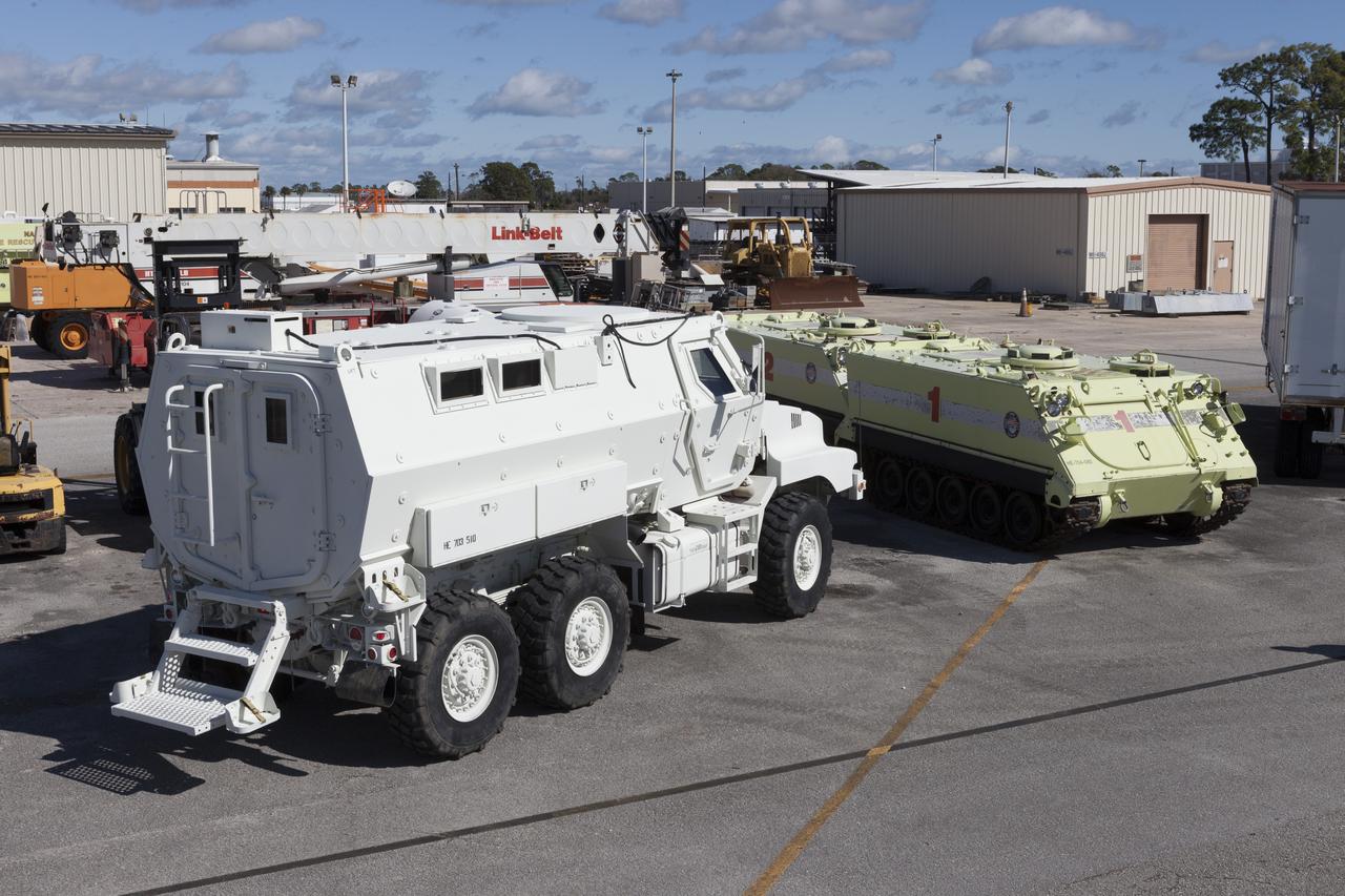 CAPE CANAVERAL, Fla. – One of four new emergency egress vehicles, called Mine-Resistant Ambush-Protection, or MRAP, vehicles sits near space shuttle-era M-113 vehicles at the Maintenance and Operations Facility at NASA’s Kennedy Space Center in Florida. The MRAPs arrived from the U.S. Army Red River Depot in Texarkana, Texas in December 2013. The vehicles were processed in and then transported to the Rotation, Processing and Surge Facility near the Vehicle Assembly Building for temporary storage. The Ground Systems Development and Operations Program at Kennedy led the efforts to an emergency egress vehicle that future astronauts could quickly use to leave the Launch Complex 39 area in case of an emergency. During crewed launches of NASA’s Space Launch System and Orion spacecraft, the MRAP will be stationed by the slidewire termination area at the pad. In case of an emergency, the crew will ride a slidewire to the ground and immediately board the MRAP for safe egress from the pad. The new vehicles replace the M-113 vehicles that were used during the Space Shuttle Program. Photo credit: NASA/Kim Shiflett