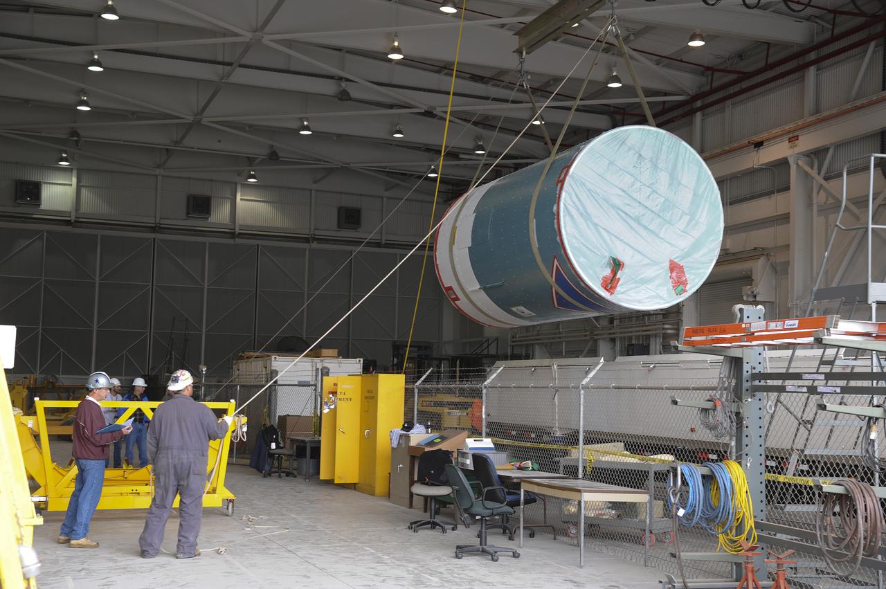 VANDENBERG AIR FORCE BASE, Calif. – Workers lift the interstage adapter, or ISA, for NASA's Orbiting Carbon Observatory-2 mission, or OCO-2, from its transportation trailer in the high bay of the Building 836 hangar on Vandenberg Air Force Base in California. OCO-2 is scheduled to launch aboard a United Launch Alliance Delta II rocket from Space Launch Complex 2 in July. The ISA is the interface between the Delta II first and second stages. The second stage engine fits within the ISA. OCO-2 will collect precise global measurements of carbon dioxide in the Earth's atmosphere and provide scientists with a better idea of the chemical compound's impacts on climate change. Scientists will analyze this data to improve our understanding of the natural processes and human activities that regulate the abundance and distribution of this important atmospheric gas. To learn more about OCO-2, visit http://oco.jpl.nasa.gov. Photo credit: NASA/Jeremy Moore, 30th Space Wing, VAFB
