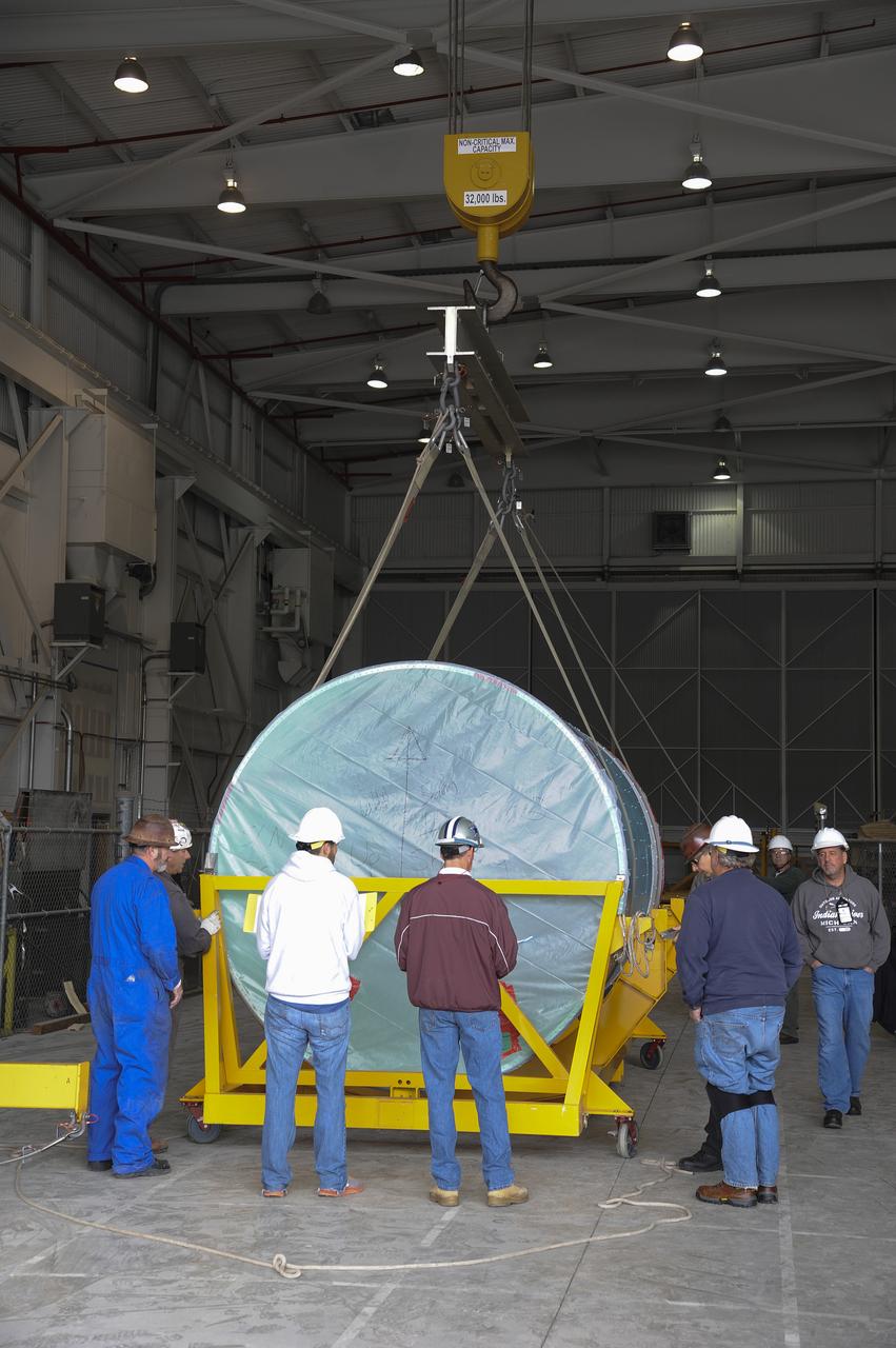VANDENBERG AIR FORCE BASE, Calif. – Workers lower the interstage adapter, or ISA, for NASA's Orbiting Carbon Observatory-2 mission, or OCO-2, into a transportation hardware cradle in the high bay of the Building 836 hangar on Vandenberg Air Force Base in California. OCO-2 is scheduled to launch aboard a United Launch Alliance Delta II rocket from Space Launch Complex 2 in July. The ISA is the interface between the Delta II first and second stages. The second stage engine fits within the ISA. OCO-2 will collect precise global measurements of carbon dioxide in the Earth's atmosphere and provide scientists with a better idea of the chemical compound's impacts on climate change. Scientists will analyze this data to improve our understanding of the natural processes and human activities that regulate the abundance and distribution of this important atmospheric gas. To learn more about OCO-2, visit http://oco.jpl.nasa.gov. Photo credit: NASA/Jeremy Moore, 30th Space Wing, VAFB
