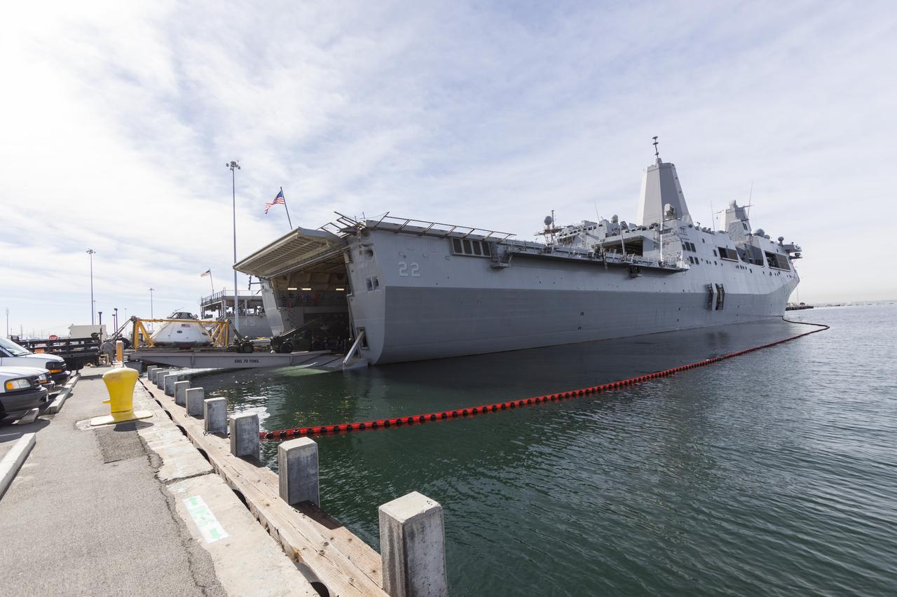 SAN DIEGO, Calif. – The Orion boilerplate test vehicle arrived at the U.S. Naval Base San Diego in California, and is being loaded aboard the USS San Diego. Orion was transported in the ship’s well deck about 100 miles offshore for an underway recovery test. NASA and the U.S. Navy are conducting tests to prepare for recovery of the Orion crew module, forward bay cover and parachutes on its return from a deep space mission. The underway recovery test will allow the teams to demonstrate and evaluate the recovery processes, procedures, hardware and personnel in open waters. The Ground Systems Development and Operations Program Orion is the exploration spacecraft designed to carry astronauts to destinations not yet explored by humans, including an asteroid and Mars. It will have emergency abort capability, sustain the crew during space travel and provide safe re-entry from deep space return velocities. The first unpiloted test flight of the Orion is scheduled to launch in 2014 atop a Delta IV rocket and in 2017 on NASA’s Space Launch System rocket. For more information, visit http://www.nasa.gov/orion. Photo credit: NASA/Cory Huston  
