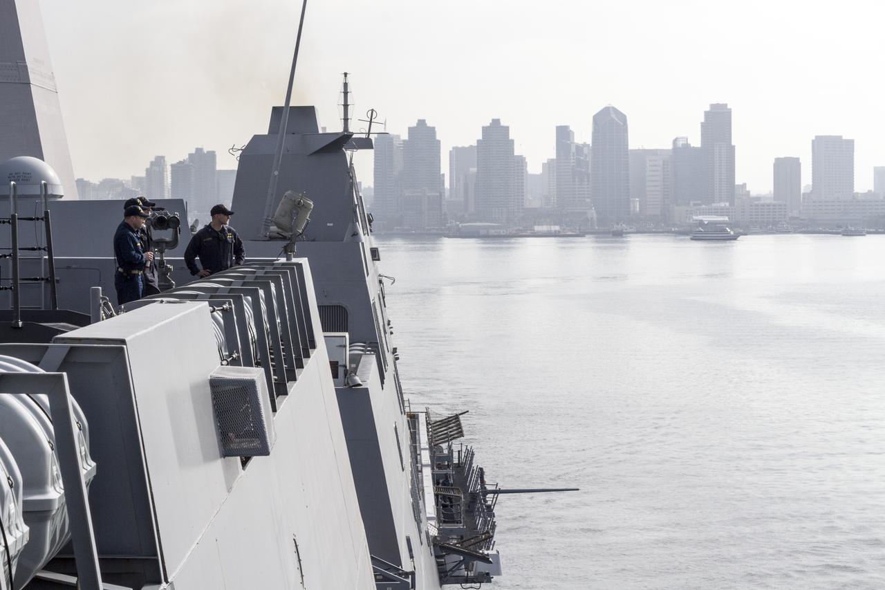 SAN DIEGO, Calif. – The skyline of San Diego, California is visible as the USS San Diego departs from the U.S. Naval Base San Diego with the Orion boilerplate test vehicle and other hardware in its well deck for an underway recovery test. About 100 miles offshore, NASA and the U.S. Navy conducted tests conducted tests to prepare for recovery of the Orion crew module, forward bay cover and parachutes on its return from a deep space mission. The underway recovery test will allow the teams to demonstrate and evaluate the recovery processes, procedures, hardware and personnel in open waters. During the testing, the tether lines were unable to support the tension caused by crew module motion that was driven by wave turbulence in the well deck of the ship. NASA and the U.S. Navy are reviewing the testing data collected to evaluate the next steps. The Ground Systems Development and Operations Program conducted the underway recovery tests. Orion is the exploration spacecraft designed to carry astronauts to destinations not yet explored by humans, including an asteroid and Mars. It will have emergency abort capability, sustain the crew during space travel and provide safe re-entry from deep space return velocities. The first unpiloted test flight of the Orion is scheduled to launch in 2014 atop a Delta IV rocket and in 2017 on NASA’s Space Launch System rocket. For more information, visit http://www.nasa.gov/orion. Photo credit: NASA/Cory Huston