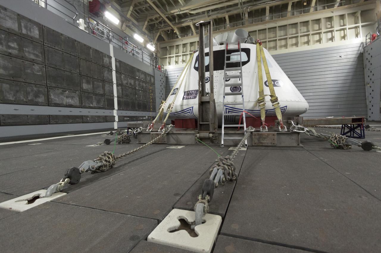 SAN DIEGO, Calif. – The Orion boilerplate test vehicle is secured in the well deck of the USS San Diego at the U.S. Naval Base San Diego in California. Orion was transported about 100 miles offshore for an underway recovery test. NASA and the U.S. Navy conducted tests to prepare for recovery of the Orion crew module, forward bay cover and parachutes on its return from a deep space mission. The underway recovery test will allow the teams to demonstrate and evaluate the recovery processes, procedures, hardware and personnel in open waters. During the testing, the tether lines were unable to support the tension caused by crew module motion that was driven by wave turbulence in the well deck of the ship. NASA and the U.S. Navy are reviewing the testing data collected to evaluate the next steps. The Ground Systems Development and Operations Program conducted the underway recovery tests. Orion is the exploration spacecraft designed to carry astronauts to destinations not yet explored by humans, including an asteroid and Mars. It will have emergency abort capability, sustain the crew during space travel and provide safe re-entry from deep space return velocities. The first unpiloted test flight of the Orion is scheduled to launch in 2014 atop a Delta IV rocket and in 2017 on NASA’s Space Launch System rocket. For more information, visit http://www.nasa.gov/orion. Photo credit: NASA/Cory Huston  