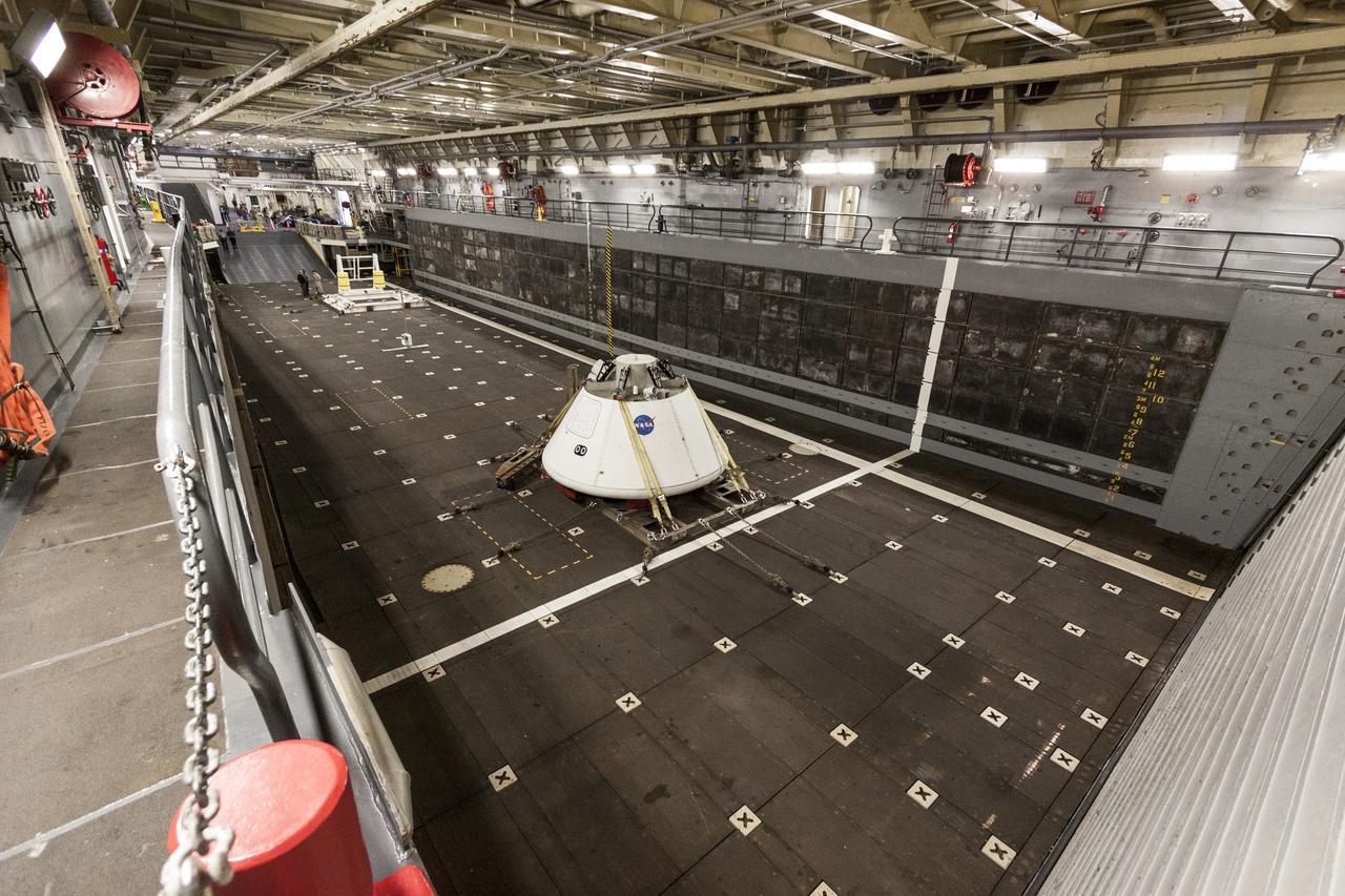 SAN DIEGO, Calif. – The Orion boilerplate test vehicle is secured in the well deck of the USS San Diego at the U.S. Naval Base San Diego in California. Orion was transported about 100 miles offshore for an underway recovery test. NASA and the U.S. Navy conducted tests to prepare for recovery of the Orion crew module, forward bay cover and parachutes on its return from a deep space mission. The underway recovery test will allow the teams to demonstrate and evaluate the recovery processes, procedures, hardware and personnel in open waters. During the testing, the tether lines were unable to support the tension caused by crew module motion that was driven by wave turbulence in the well deck of the ship. NASA and the U.S. Navy are reviewing the testing data collected to evaluate the next steps. The Ground Systems Development and Operations Program conducted the underway recovery tests. Orion is the exploration spacecraft designed to carry astronauts to destinations not yet explored by humans, including an asteroid and Mars. It will have emergency abort capability, sustain the crew during space travel and provide safe re-entry from deep space return velocities. The first unpiloted test flight of the Orion is scheduled to launch in 2014 atop a Delta IV rocket and in 2017 on NASA’s Space Launch System rocket. For more information, visit http://www.nasa.gov/orion. Photo credit: NASA/Cory Huston