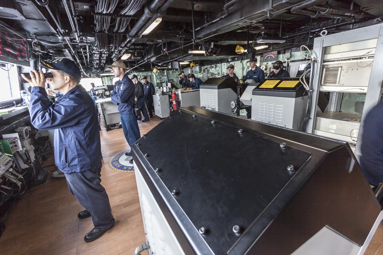 SAN DIEGO, Calif. – At the U.S. Naval Base San Diego in California, the USS San Diego heads out to sea with the Orion boilerplate test vehicle and other hardware in its well deck for an underway recovery test. U.S. Navy personnel monitor conditions as the ship leaves port. About 100 miles offshore, NASA and the U.S. Navy conducted tests to prepare for recovery of the Orion crew module, forward bay cover and parachutes on its return from a deep space mission. The underway recovery test will allow the teams to demonstrate and evaluate the recovery processes, procedures, hardware and personnel in open waters. During the testing, the tether lines were unable to support the tension caused by crew module motion that was driven by wave turbulence in the well deck of the ship. NASA and the U.S. Navy are reviewing the testing data collected to evaluate the next steps. The Ground Systems Development and Operations Program conducted the underway recovery tests. Orion is the exploration spacecraft designed to carry astronauts to destinations not yet explored by humans, including an asteroid and Mars. It will have emergency abort capability, sustain the crew during space travel and provide safe re-entry from deep space return velocities. The first unpiloted test flight of the Orion is scheduled to launch in 2014 atop a Delta IV rocket and in 2017 on NASA’s Space Launch System rocket. For more information, visit http://www.nasa.gov/orion. Photo credit: NASA/Cory Huston  