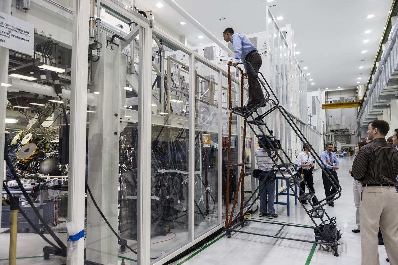 CAPE CANAVERAL, Fla. -- In the Operations and Checkout Building of NASA's Kennedy Space Center in Florida, astronaut candidate Andrew Morgan looks over work platforms to gain a look at the Orion spacecraft being prepared for Exploration Flight Test EFT-1. Plans call for the Lockheed Martin-built Orion to launch atop a United Launch Alliance Delta IV Heavy rocket from Cape Canaveral Air Force Station. The astronaut class of 2013 was selected by NASA after an extensive year-and-a-half search. The new group will help the agency push the boundaries of exploration and travel to new destinations in the solar system. To learn more about the astronaut class of 2013, visit: http://www.nasa.gov/astronauts/2013astroclass.html Photo credit: NASA/Kim Shiflett Selected image has been cropped