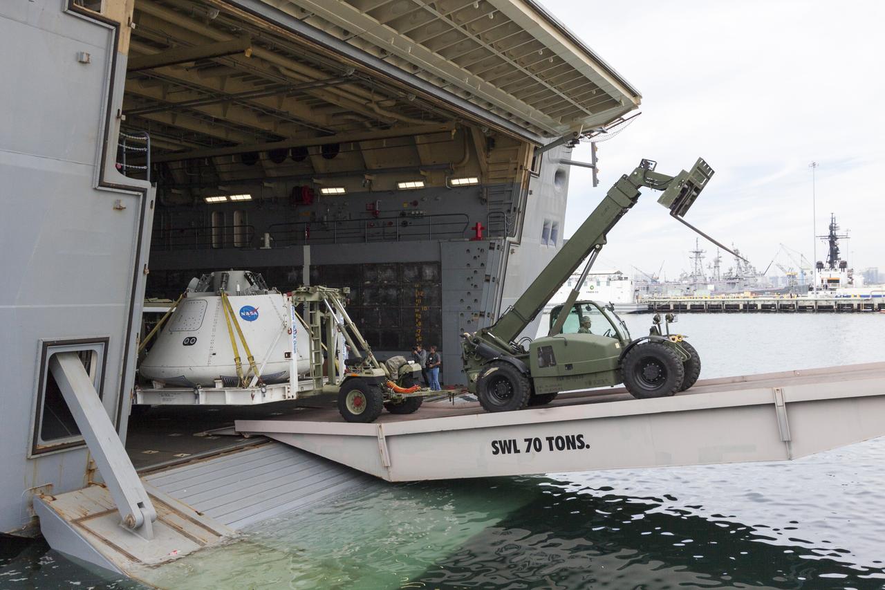 SAN DIEGO, Calif. – The Orion boilerplate test vehicle is being offloaded from the USS San Diego at the U.S. Naval Base San Diego in California. Orion was transported in the ship’s well deck about 100 miles offshore for an underway recovery test. NASA and the U.S. Navy conducted tests to prepare for recovery of the Orion crew module, forward bay cover and parachutes on its return from a deep space mission. The underway recovery test allowed the teams to demonstrate and evaluate the recovery processes, procedures, hardware and personnel in open waters. During the testing, the tether lines were unable to support the tension caused by crew module motion that was driven by wave turbulence in the well deck of the ship. NASA and the U.S. Navy are reviewing the testing data collected to evaluate the next steps. The Ground Systems Development and Operations Program was conducting the recovery tests. Orion is the exploration spacecraft designed to carry astronauts to destinations not yet explored by humans, including an asteroid and Mars. It will have emergency abort capability, sustain the crew during space travel and provide safe re-entry from deep space return velocities. The first unpiloted test flight of the Orion is scheduled to launch in 2014 atop a Delta IV rocket and in 2017 on NASA’s Space Launch System rocket. For more information, visit http://www.nasa.gov/orion. Photo credit: NASA/Cory Huston