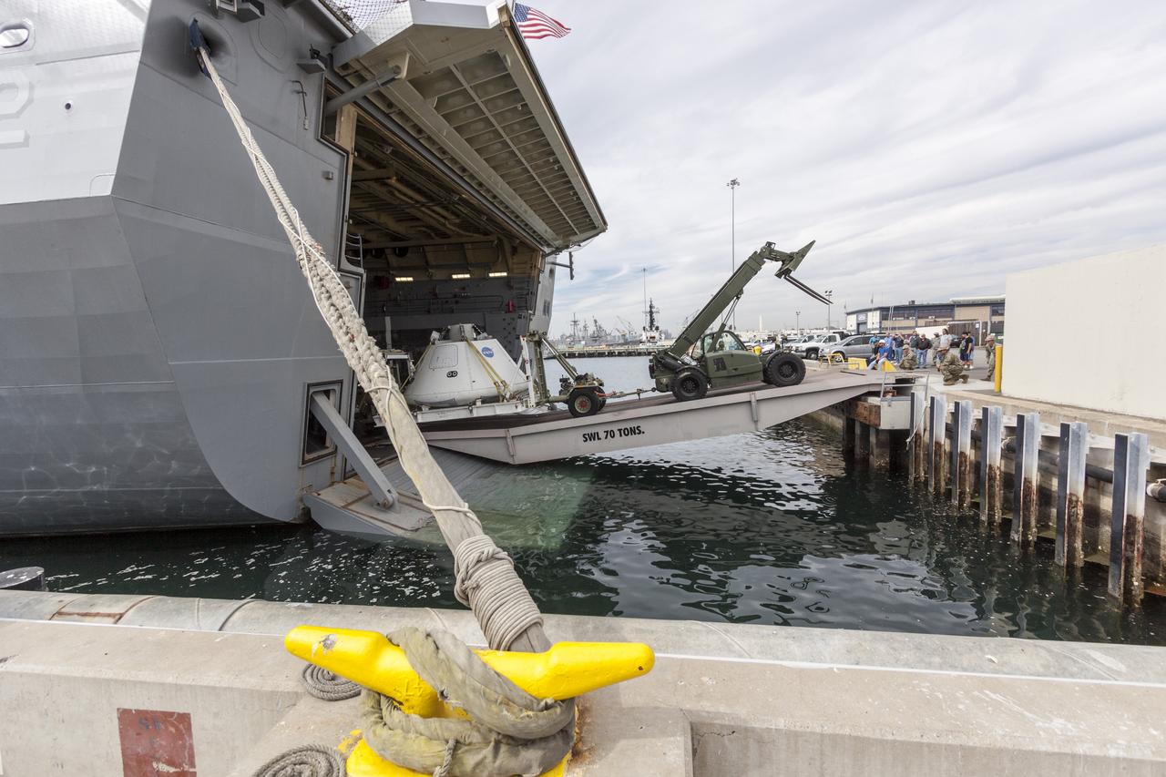 SAN DIEGO, Calif. – The Orion boilerplate test vehicle is being offloaded from the USS San Diego at the U.S. Naval Base San Diego in California. Orion was transported in the ship’s well deck about 100 miles offshore for an underway recovery test. NASA and the U.S. Navy conducted tests to prepare for recovery of the Orion crew module, forward bay cover and parachutes on its return from a deep space mission. The underway recovery test allowed the teams to demonstrate and evaluate the recovery processes, procedures, hardware and personnel in open waters. During the testing, the tether lines were unable to support the tension caused by crew module motion that was driven by wave turbulence in the well deck of the ship. NASA and the U.S. Navy are reviewing the testing data collected to evaluate the next steps. The Ground Systems Development and Operations Program was conducting the recovery tests. Orion is the exploration spacecraft designed to carry astronauts to destinations not yet explored by humans, including an asteroid and Mars. It will have emergency abort capability, sustain the crew during space travel and provide safe re-entry from deep space return velocities. The first unpiloted test flight of the Orion is scheduled to launch in 2014 atop a Delta IV rocket and in 2017 on NASA’s Space Launch System rocket. For more information, visit http://www.nasa.gov/orion. Photo credit: NASA/Cory Huston  