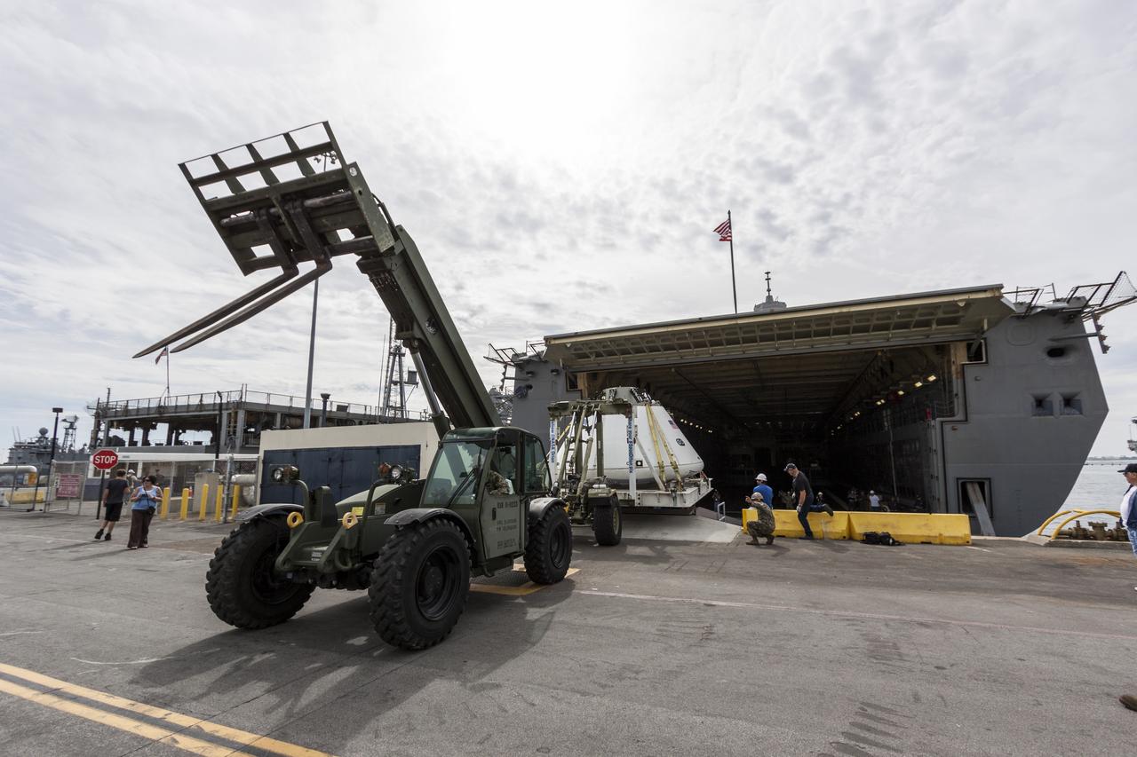 SAN DIEGO, Calif. – The Orion boilerplate test vehicle is being offloaded from the USS San Diego at the U.S. Naval Base San Diego in California. Orion was transported in the ship’s well deck about 100 miles offshore for an underway recovery test. NASA and the U.S. Navy conducted tests to prepare for recovery of the Orion crew module, forward bay cover and parachutes on its return from a deep space mission. The underway recovery test allowed the teams to demonstrate and evaluate the recovery processes, procedures, hardware and personnel in open waters. During the testing, the tether lines were unable to support the tension caused by crew module motion that was driven by wave turbulence in the well deck of the ship. NASA and the U.S. Navy are reviewing the testing data collected to evaluate the next steps. The Ground Systems Development and Operations Program was conducting the recovery tests. Orion is the exploration spacecraft designed to carry astronauts to destinations not yet explored by humans, including an asteroid and Mars. It will have emergency abort capability, sustain the crew during space travel and provide safe re-entry from deep space return velocities. The first unpiloted test flight of the Orion is scheduled to launch in 2014 atop a Delta IV rocket and in 2017 on NASA’s Space Launch System rocket. For more information, visit http://www.nasa.gov/orion. Photo credit: NASA/Cory Huston  