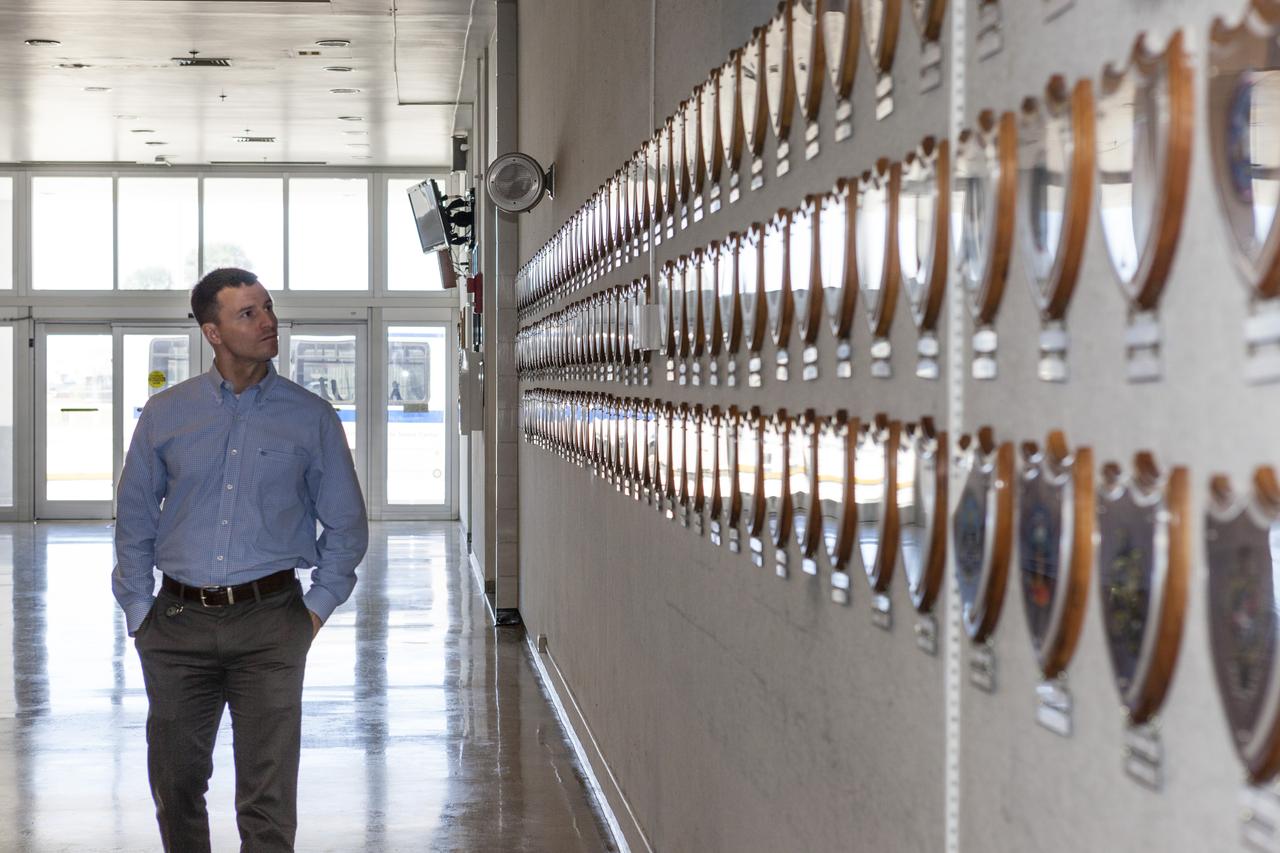 CAPE CANAVERAL, Fla. – NASA astronaut candidate Andrew Morgan surveys the mission plaques on the wall of the Launch Control Center at Kennedy Space Center in Florida during a daylong set of briefings and tours of different facilities at NASA's primary launch center. The astronaut class of 2013 was selected by NASA after an extensive year-and-a-half search. The new group will help the agency push the boundaries of exploration and travel to new destinations in the solar system. To learn more about the astronaut class of 2013, visit: http://www.nasa.gov/astronauts/2013astroclass.html Photo credit: NASA/Kim Shiflett