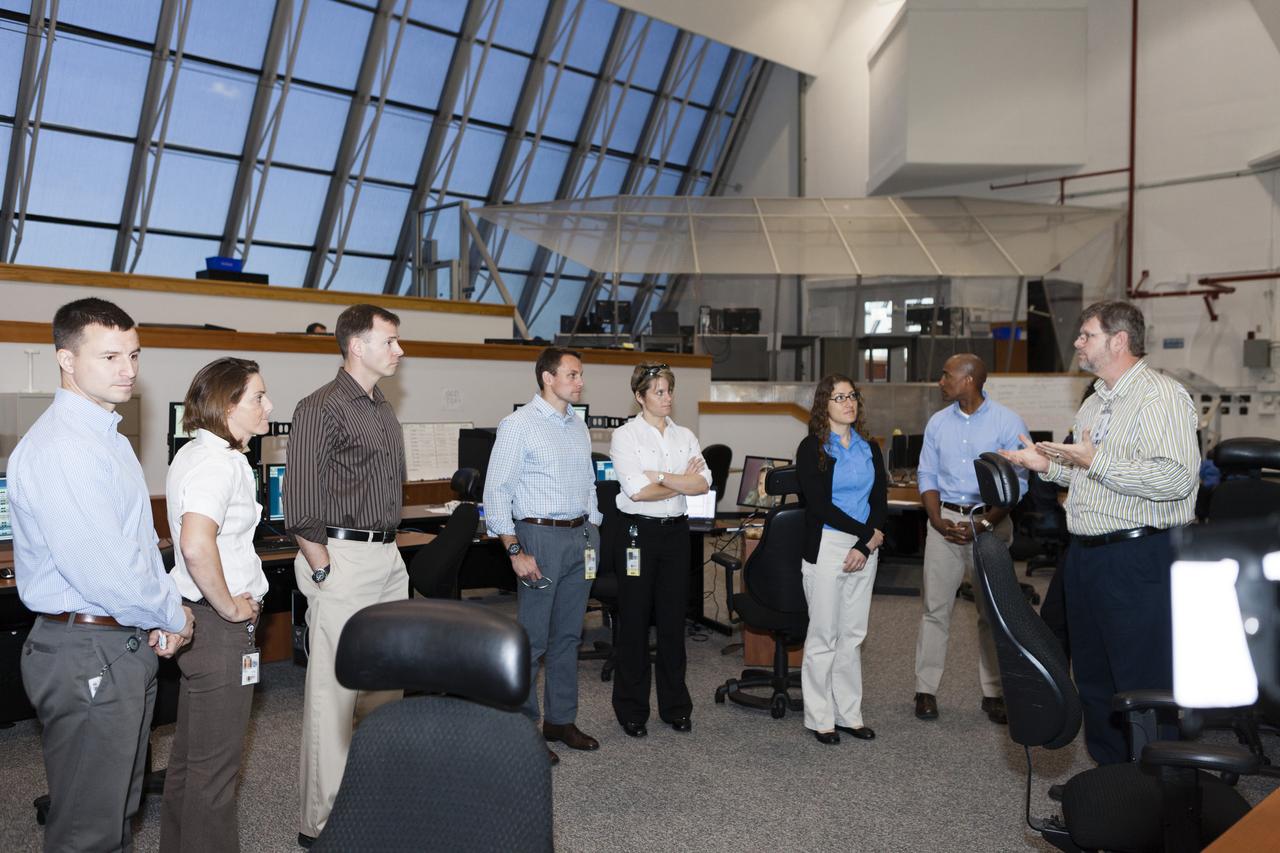 CAPE CANAVERAL, Fla. – NASA astronaut candidates Andrew Morgan, from left, Nicole Mann, Tyler Nick Hague, Josh Cassada, Anne McClain, Christina Hammock and Victor Glover listen as Steve Cox or Flight Systems and Operations Integration in Kennedy Ground Systems Development and Operations, far right, briefed on firing rooms inside the Launch Control Center at Kennedy Space Center in Florida during a daylong set of briefings and tours of different facilities at NASA's primary launch center. The astronaut class of 2013 was selected by NASA after an extensive year-and-a-half search. The new group will help the agency push the boundaries of exploration and travel to new destinations in the solar system. To learn more about the astronaut class of 2013, visit: http://www.nasa.gov/astronauts/2013astroclass.html Photo credit: NASA/Kim Shiflett