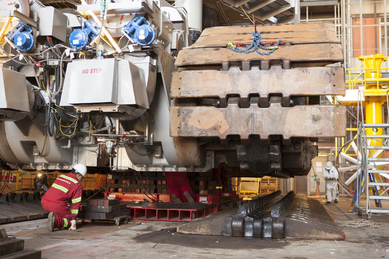 CAPE CANAVERAL, Fla. – Inside the Vehicle Assembly Building at NASA’s Kennedy Space Center in Florida, ground support technicians monitor the progress as the B and D truck sections of crawler-transporter 2, or CT-2, are being raised up to prepare for installation of new roller bearing assemblies. Sections of the crawler’s large metal tracks have been removed. Work continues in high bay 2 to upgrade CT-2. The modifications are designed to ensure CT-2’s ability to transport launch vehicles currently in development, such as the agency’s Space Launch System, to the launch pad. The Ground Systems Development and Operations Program office at Kennedy is overseeing the upgrades. For more than 45 years the crawler-transporters were used to transport the mobile launcher platform and the Apollo-Saturn V rockets and, later, space shuttles to Launch Pads 39A and B. For more information, visit: http://www.nasa.gov/exploration/systems/ground/crawler-transporter. Photo credit: NASA/Dimitri Gerondidakis