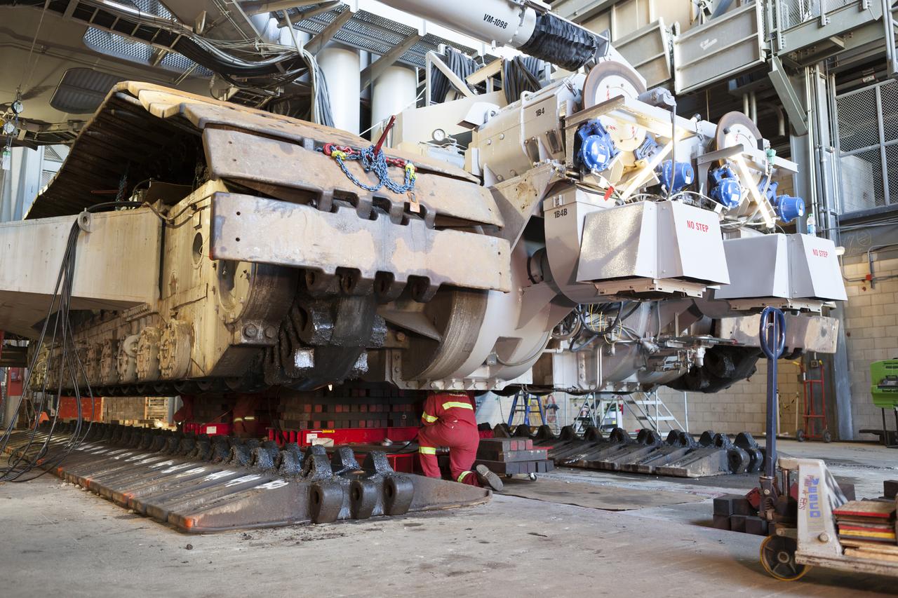 CAPE CANAVERAL, Fla. – Inside the Vehicle Assembly Building at NASA’s Kennedy Space Center in Florida, a technician monitors the progress as the B and D truck sections of crawler-transporter 2, or CT-2, are raised up to prepare for installation of new roller bearing assemblies. Sections of the crawler’s large metal tracks have been removed. Work continues in high bay 2 to upgrade CT-2. The modifications are designed to ensure CT-2’s ability to transport launch vehicles currently in development, such as the agency’s Space Launch System, to the launch pad. The Ground Systems Development and Operations Program office at Kennedy is overseeing the upgrades. For more than 45 years the crawler-transporters were used to transport the mobile launcher platform and the Apollo-Saturn V rockets and, later, space shuttles to Launch Pads 39A and B. For more information, visit: http://www.nasa.gov/exploration/systems/ground/crawler-transporter. Photo credit: NASA/Dimitri Gerondidakis