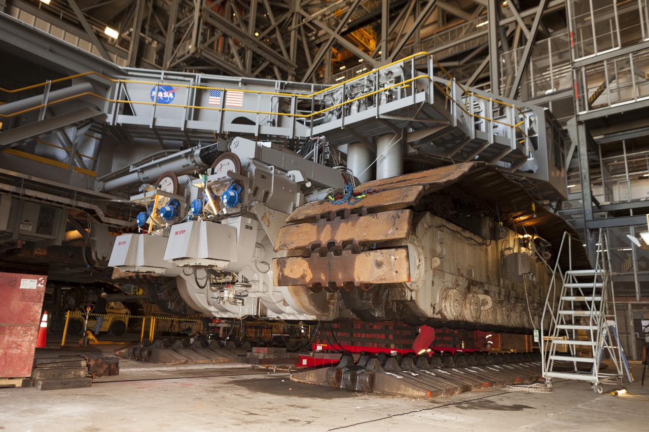 CAPE CANAVERAL, Fla. – Inside the Vehicle Assembly Building at NASA’s Kennedy Space Center in Florida, the B and D truck sections of crawler-transporter 2, or CT-2, have been raised up to prepare for installation of new roller bearing assemblies. Sections of the crawler’s large metal tracks have been removed. Work continues in high bay 2 to upgrade CT-2. The modifications are designed to ensure CT-2’s ability to transport launch vehicles currently in development, such as the agency’s Space Launch System, to the launch pad. The Ground Systems Development and Operations Program office at Kennedy is overseeing the upgrades. For more than 45 years the crawler-transporters were used to transport the mobile launcher platform and the Apollo-Saturn V rockets and, later, space shuttles to Launch Pads 39A and B. For more information, visit: http://www.nasa.gov/exploration/systems/ground/crawler-transporter. Photo credit: NASA/Dimitri Gerondidakis