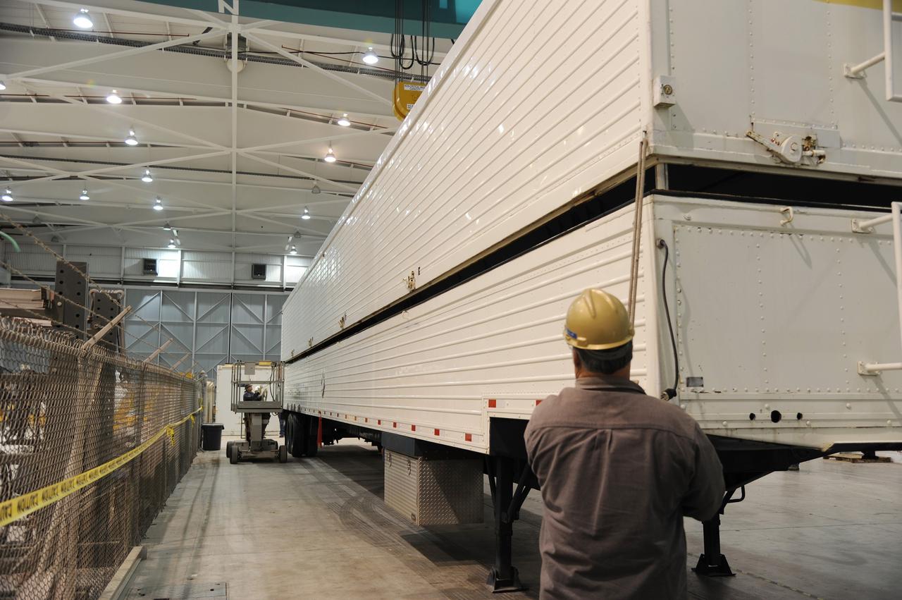 VANDENBERG AIR FORCE BASE, Calif. – Workers prepare to remove the cover of the transportation trailer protecting the second stage for NASA's Orbiting Carbon Observatory-2 mission, or OCO-2, in the high bay of the Building 836 hangar on Vandenberg Air Force Base in California.    OCO-2 is scheduled to launch aboard a United Launch Alliance Delta II rocket from Space Launch Complex 2 in July. The rocket's second stage will insert OCO-2 into a polar Earth orbit.  OCO-2 will collect precise global measurements of carbon dioxide in the Earth's atmosphere and provide scientists with a better idea of the chemical compound's impacts on climate change. Scientists will analyze this data to improve our understanding of the natural processes and human activities that regulate the abundance and distribution of this important atmospheric gas. To learn more about OCO-2, visit http://oco.jpl.nasa.gov.  Photo credit: NASA/Arron Tauman, 30th Space Wing, VAFB