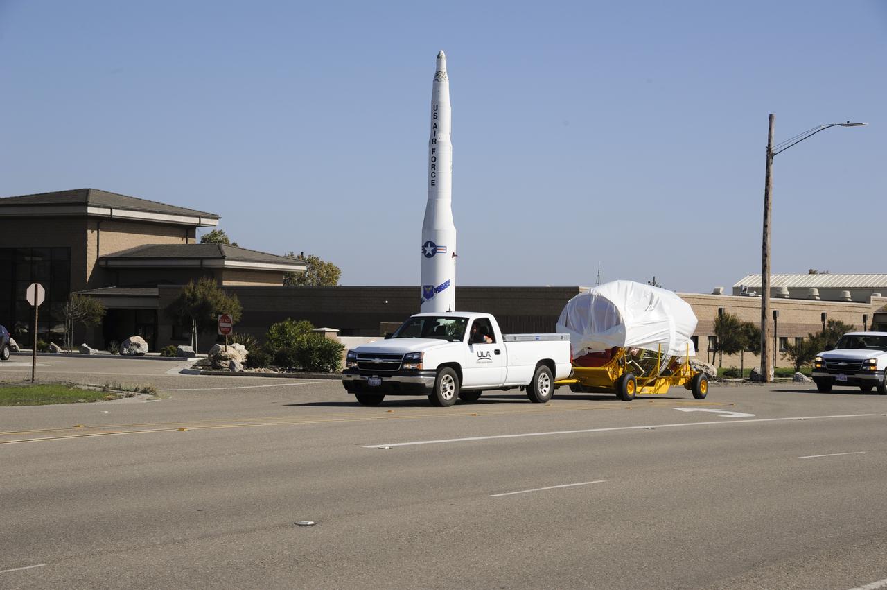 VANDENBERG AIR FORCE BASE, Calif. – The second stage for NASA's Orbiting Carbon Observatory-2 mission, or OCO-2, passes a static display of a U.S. Air Force Minuteman III intercontinental ballistic missile on its move from the Building 836 hangar to the Horizontal Processing Facility at Space Launch Complex 2 on Vandenberg Air Force Base in California. OCO-2 is scheduled to launch aboard a United Launch Alliance Delta II rocket in July. The rocket's second stage will insert OCO-2 into a polar Earth orbit. OCO-2 will collect precise global measurements of carbon dioxide in the Earth's atmosphere and provide scientists with a better idea of the chemical compound's impacts on climate change. Scientists will analyze this data to improve our understanding of the natural processes and human activities that regulate the abundance and distribution of this important atmospheric gas. To learn more about OCO-2, visit http://oco.jpl.nasa.gov. Photo credit: NASA/Arron Tauman, 30th Space Wing, VAFB