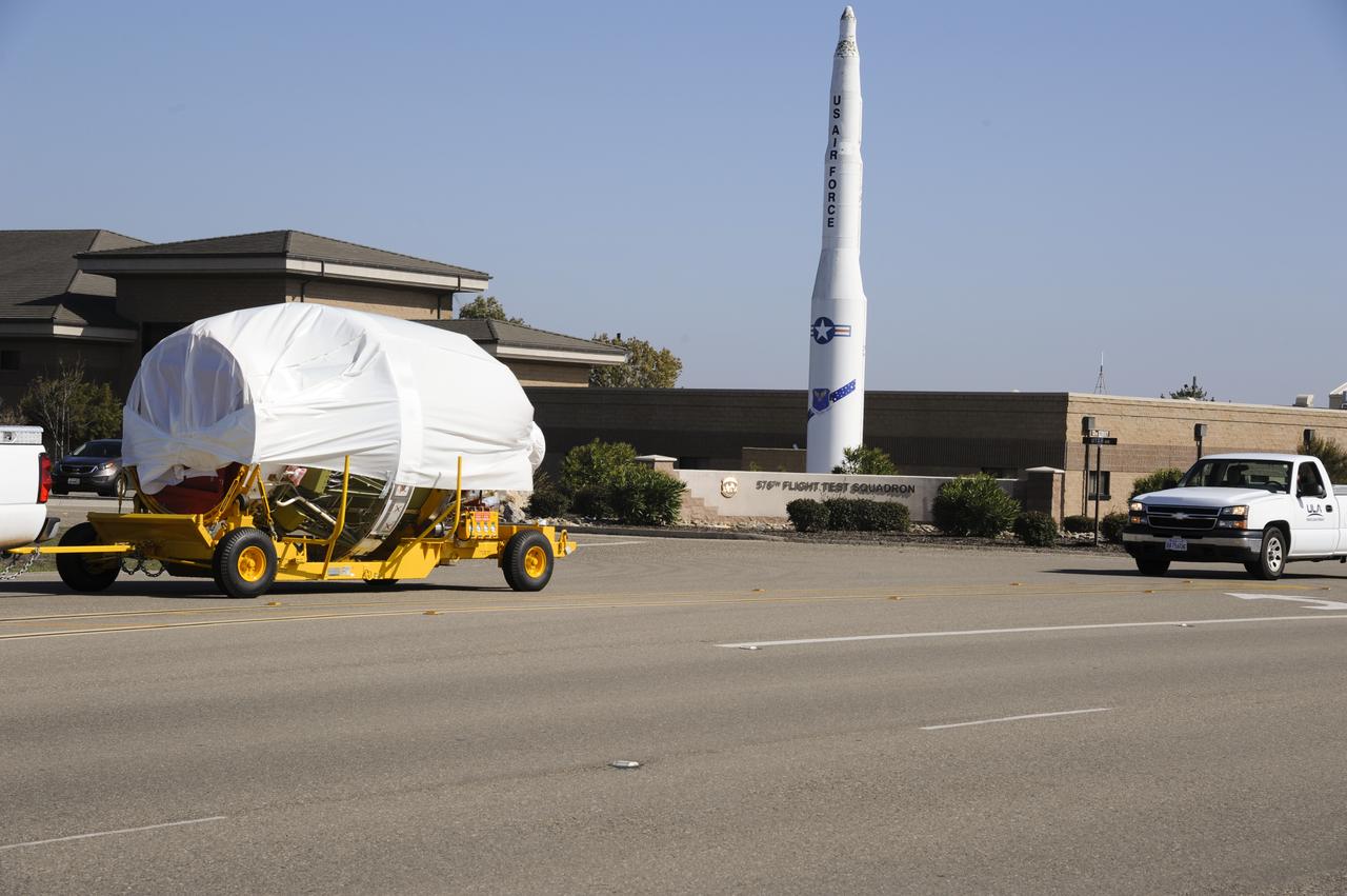 VANDENBERG AIR FORCE BASE, Calif. – The second stage for NASA's Orbiting Carbon Observatory-2 mission, or OCO-2, passes a static display of a U.S. Air Force Minuteman III intercontinental ballistic missile on its move from the Building 836 hangar to the Horizontal Processing Facility at Space Launch Complex 2 on Vandenberg Air Force Base in California. OCO-2 is scheduled to launch aboard a United Launch Alliance Delta II rocket in July. The rocket's second stage will insert OCO-2 into a polar Earth orbit. OCO-2 will collect precise global measurements of carbon dioxide in the Earth's atmosphere and provide scientists with a better idea of the chemical compound's impacts on climate change. Scientists will analyze this data to improve our understanding of the natural processes and human activities that regulate the abundance and distribution of this important atmospheric gas. To learn more about OCO-2, visit http://oco.jpl.nasa.gov. Photo credit: NASA/Arron Tauman, 30th Space Wing, VAFB