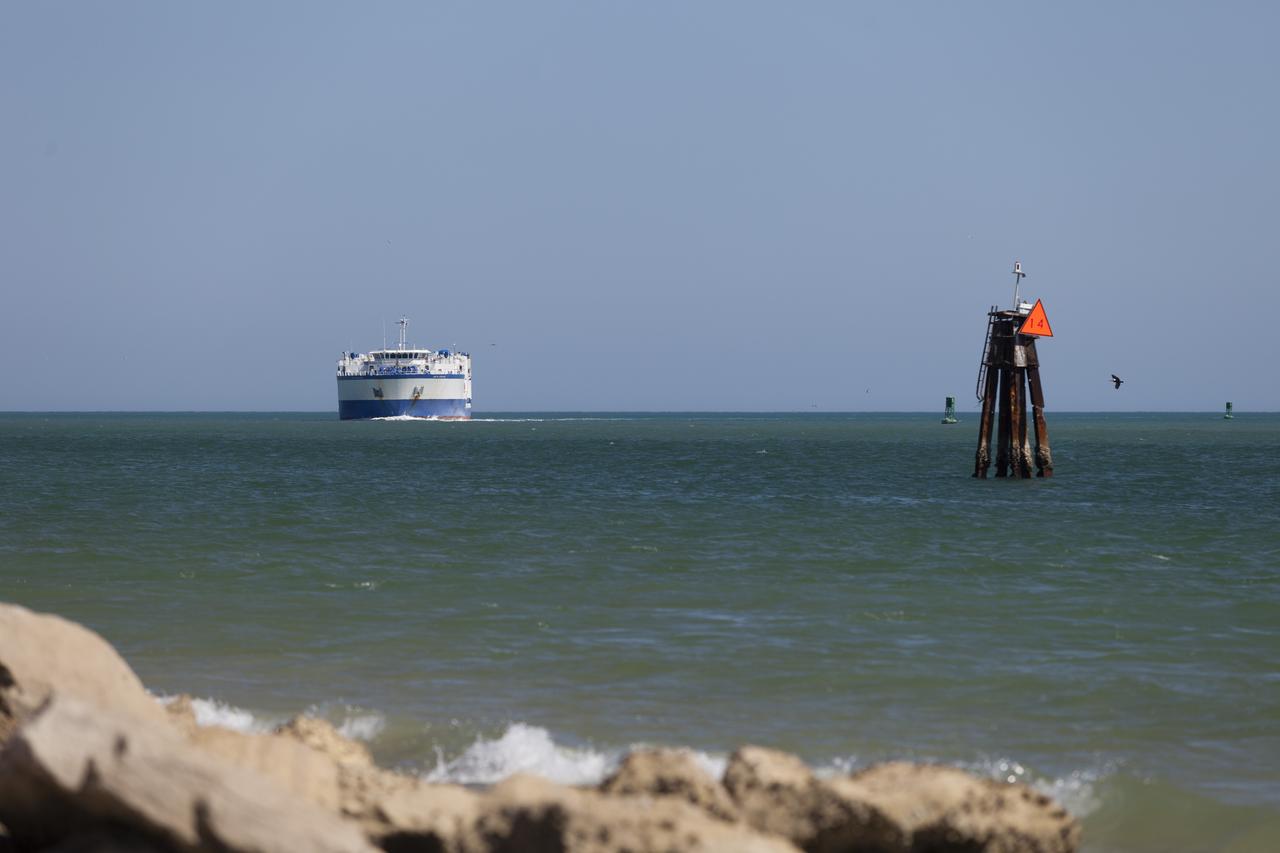 CAPE CANAVERAL, Fla. – The United Launch Alliance barge Delta Mariner approaches the mouth of Port Canaveral in Florida. The barge is carrying two of the booster stages for the Delta IV Heavy rocket slated for Orion's Exploration Flight Test-1, or EFT-1. Orion is the exploration spacecraft designed to carry astronauts to destinations not yet explored by humans. It will have emergency abort capability, sustain the crew during space travel and provide safe re-entry from deep-space return velocities. The first unpiloted test flight of Orion is scheduled to launch in September 2014 atop a Delta IV Heavy rocket and in 2017 on NASA’s Space Launch System rocket. For more information, visit www.nasa.gov/orion. Photo credit: NASA/Frankie Martin