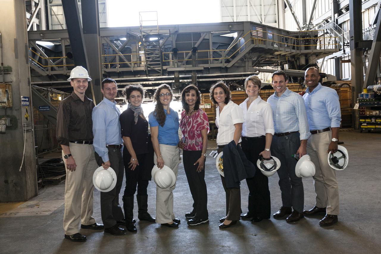 CAPE CANAVERAL, Fla. - NASA astronaut candidates Tyler "Nick" Hague, from left, Andrew Morgan, Jessica Meir, Christina Hammock, Mary Hanna, crawler-transporter integration manager, astronaut candidates Nicole Mann, Anne McClain, Josh Cassada and Victor Glover pose in front of a crawler-transporter inside the Vehicle Assembly Building at NASA's Kennedy Space Center during a daylong set of briefings and tours of different facilities at NASA's primary launch center. The astronaut class of 2013 was selected by NASA after an extensive year-and-a-half search. The new group will help the agency push the boundaries of exploration and travel to new destinations in the solar system. To learn more about the astronaut class of 2013, visit: http://www.nasa.gov/astronauts/2013astroclass.html Photo credit: NASA/Kim Shiflett
