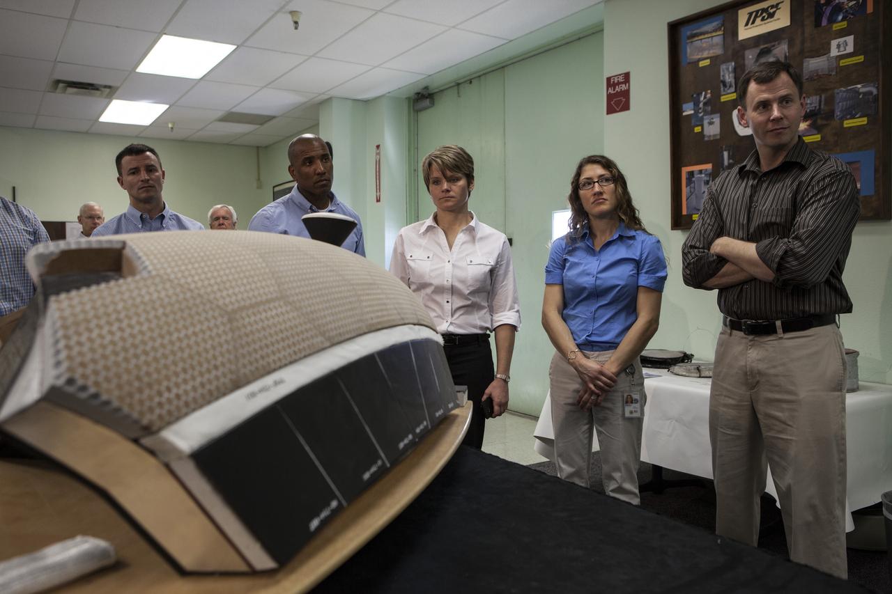 CAPE CANAVERAL, Fla. -- In the Thermal Protection System Facility NASA's Kennedy Space Center in Florida, agency astronaut candidates are briefed on tiles being manufactured for the agency's Orion spacecraft. Participating in the briefing, from the left, are Andrew Morgan, Victor Glover, Anne McClain, Christina Hammock and Tyler "Nick" Hague. Plans call for the Lockheed Martin-built Orion to launch atop a United Launch Alliance Delta IV Heavy rocket from Cape Canaveral Air Force Station on Exploration Flight Test EFT-1 later this year. The astronaut class of 2013 was selected by NASA after an extensive year-and-a-half search. The new group will help the agency push the boundaries of exploration and travel to new destinations in the solar system. To learn more about the astronaut class of 2013, visit: http://www.nasa.gov/astronauts/2013astroclass.html Photo credit: NASA/Kim Shiflett