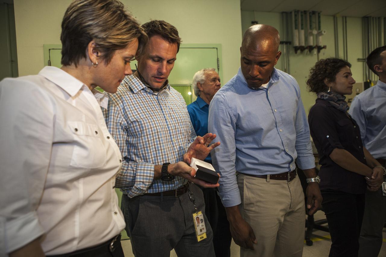 CAPE CANAVERAL, Fla. -- In the Thermal Protection System Facility NASA's Kennedy Space Center in Florida, agency astronaut candidates are briefed on tiles being manufactured for the agency's Orion spacecraft. Josh Cassada holds a tile sample as Anne McClain, left, and Victor Glover look on.  Plans call for the Lockheed Martin-built Orion to launch atop a United Launch Alliance Delta IV Heavy rocket from Cape Canaveral Air Force Station on Exploration Flight Test EFT-1 later this year. The astronaut class of 2013 was selected by NASA after an extensive year-and-a-half search. The new group will help the agency push the boundaries of exploration and travel to new destinations in the solar system. To learn more about the astronaut class of 2013, visit: http://www.nasa.gov/astronauts/2013astroclass.html Photo credit: NASA/Kim Shiflett