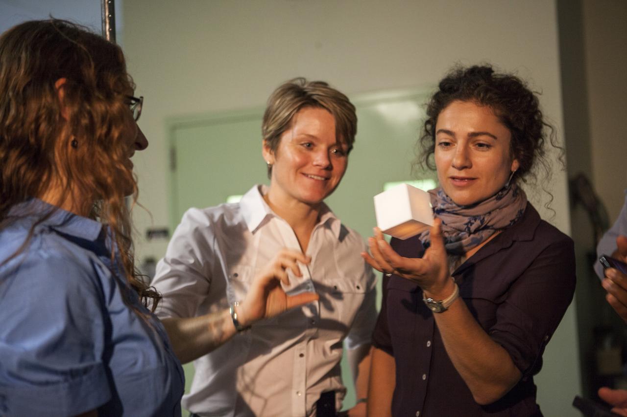 CAPE CANAVERAL, Fla. -- In the Thermal Protection System Facility NASA's Kennedy Space Center in Florida, agency astronaut candidates are briefed on tiles being manufactured for the agency's Orion spacecraft. Jessica Meir, right, holds a heated tile sample demonstrating its ability to protect a spacecraft during the heat of reentry. Looking on, are Christina Hammock, left, and Anne McClain. Plans call for the Lockheed Martin-built Orion to launch atop a United Launch Alliance Delta IV Heavy rocket from Cape Canaveral Air Force Station on Exploration Flight Test EFT-1 later this year. The astronaut class of 2013 was selected by NASA after an extensive year-and-a-half search. The new group will help the agency push the boundaries of exploration and travel to new destinations in the solar system. To learn more about the astronaut class of 2013, visit: http://www.nasa.gov/astronauts/2013astroclass.html Photo credit: NASA/Kim Shiflett