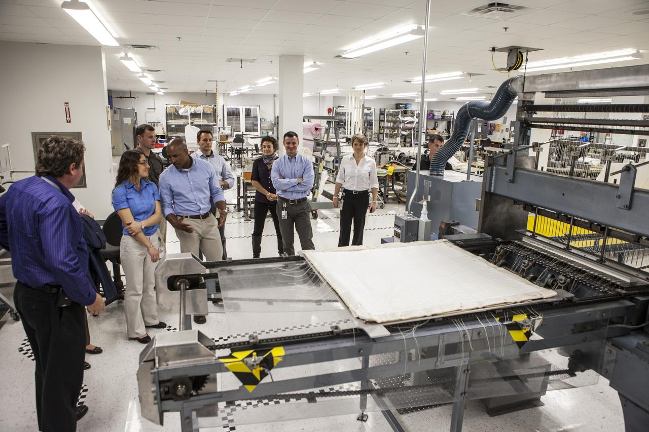 CAPE CANAVERAL, Fla. -- In the Thermal Protection System Facility NASA's Kennedy Space Center in Florida, agency astronaut candidates are briefed on thermal blankets being manufactured for agency spacecraft by TPSF manager, Martin Wilson of Jacobs Technology, far left. Participating in the briefing, from the left, are Christina Hammock, Tyler ‘Nick’ Hague, Victor Glover, John Cassada, Jessica Meir, Andrew Morgan and Anne McClain. Plans call for the Lockheed Martin-built Orion to launch atop a United Launch Alliance Delta IV Heavy rocket from Cape Canaveral Air Force Station on Exploration Flight Test EFT-1 later this year. The astronaut class of 2013 was selected by NASA after an extensive year-and-a-half search. The new group will help the agency push the boundaries of exploration and travel to new destinations in the solar system. To learn more about the astronaut class of 2013, visit: http://www.nasa.gov/astronauts/2013astroclass.html Photo credit: NASA/Kim Shiflett
