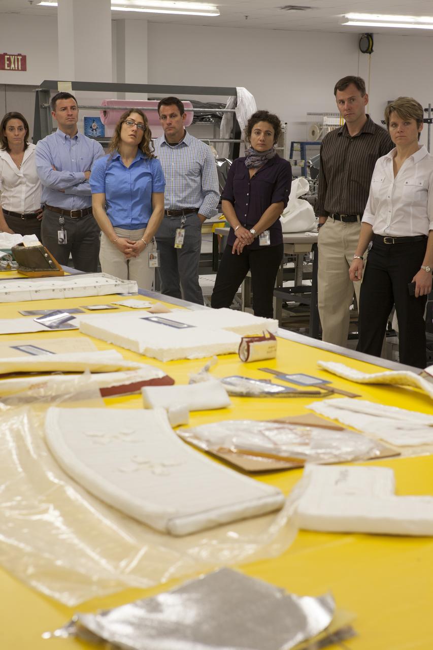 CAPE CANAVERAL, Fla. -- In the Thermal Protection System Facility NASA's Kennedy Space Center in Florida, agency astronaut candidates are briefed on thermal blankets being manufactured for agency spacecraft. Looking at sample thermal blankets are, from the left, Nicole Mann, Andrew Morgan, Christina Hammock, Josh Cassada, Jessica Meir, Tyler ‘Nick’ Hague, and Anne McClain. Plans call for the Lockheed Martin-built Orion to launch atop a United Launch Alliance Delta IV Heavy rocket from Cape Canaveral Air Force Station on Exploration Flight Test EFT-1 later this year. The astronaut class of 2013 was selected by NASA after an extensive year-and-a-half search. The new group will help the agency push the boundaries of exploration and travel to new destinations in the solar system. To learn more about the astronaut class of 2013, visit: http://www.nasa.gov/astronauts/2013astroclass.html Photo credit: NASA/Kim Shiflett