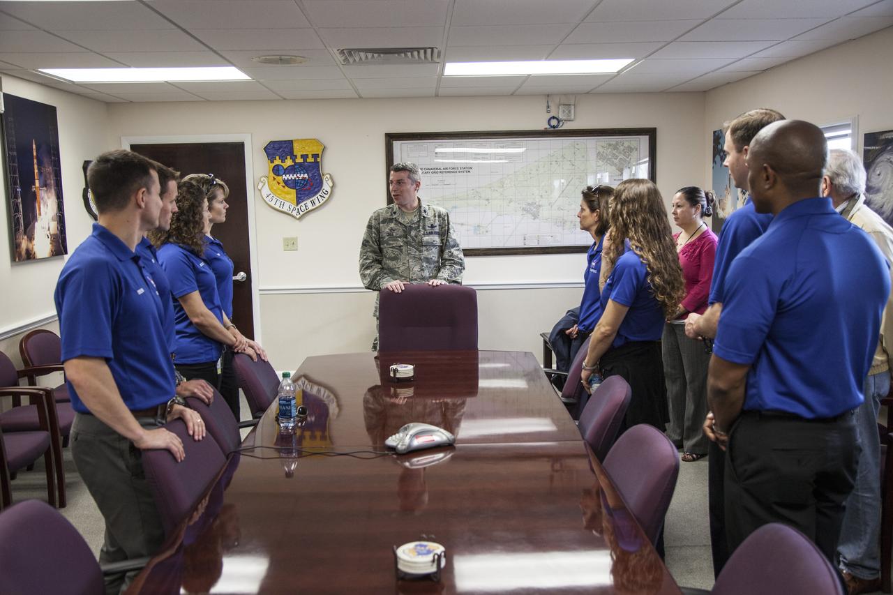 CAPE CANAVERAL, Fla. – NASA's latest astronaut class meets with a member of the 45th Space Wing in the Cape Commander's Building at Cape Canaveral Air Force Station in Florida, adjacent to NASA's Kennedy Space Center. The astronaut candidates are, from left, Josh Cassada, Andrew Morgan, Jessica Meir, Anne McClain, Nicole Mann, Christina Hammock, Tylor "Nick" Hague and Victor Glover. The astronaut class of 2013 was selected by NASA after an extensive year-and-a-half search. The new group will help the agency push the boundaries of exploration and travel to new destinations in the solar system. To learn more about the astronaut class of 2013, visit: http://www.nasa.gov/astronauts/2013astroclass.html Photo credit: NASA/Frankie Martin