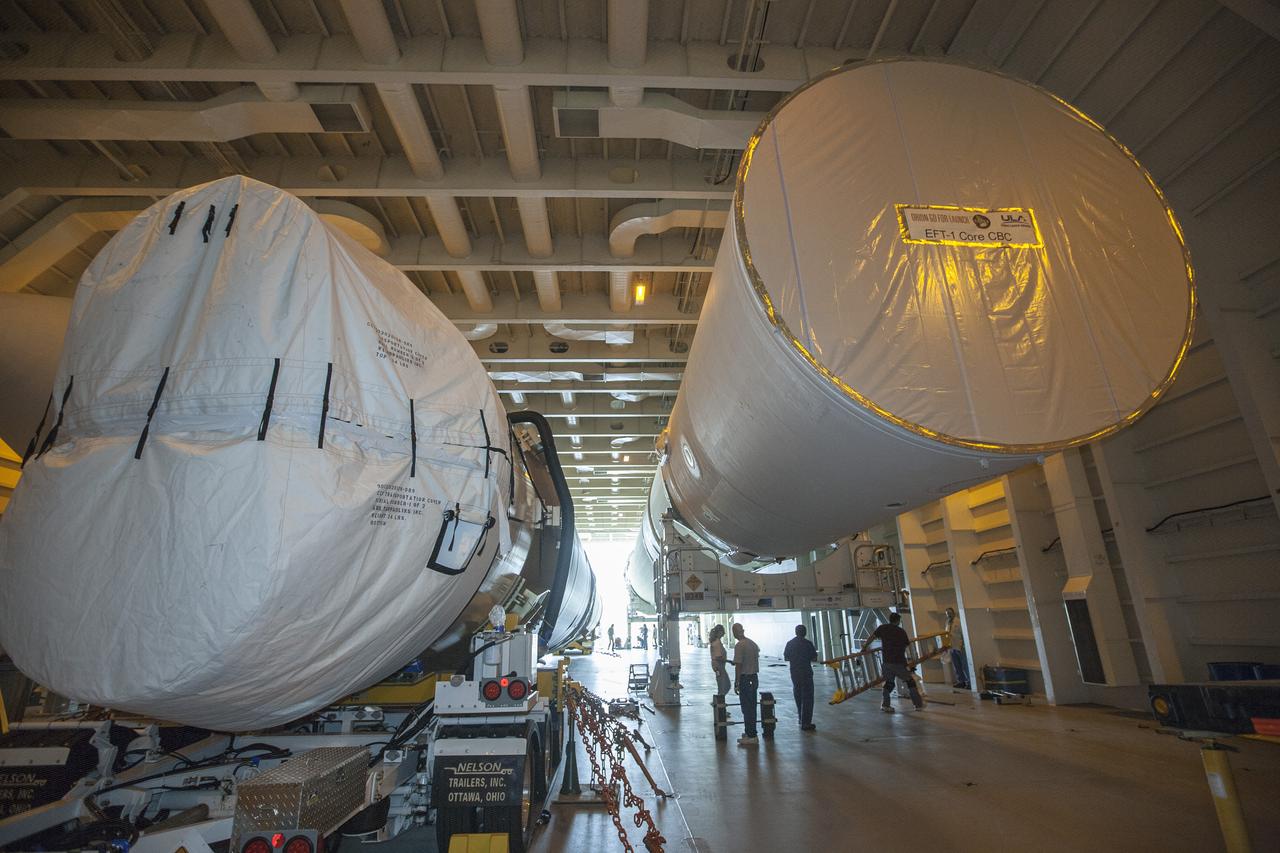 CAPE CANAVERAL, Fla. – A barge arrives at the U.S. Army Outpost wharf at Port Canaveral in Florida, carrying two of the three United Launch Alliance Delta IV heavy boosters for NASA’s upcoming Exploration Flight Test-1, or EFT-1, mission with the Orion spacecraft. The core booster and starboard booster will be offloaded and then transported to the Horizontal Integration Facility, or HIF, at Space Launch Complex 37 on Cape Canaveral Air Force Station. The port booster and the upper stage are planned to be shipped to Cape Canaveral in April. At the HIF, all three boosters will be processed and checked out before being moved to the nearby launch pad and hoisted into position. During the EFT-1 mission, Orion will travel farther into space than any human spacecraft has gone in more than 40 years. The data gathered during the flight will influence design decisions, validate existing computer models and innovative new approaches to space systems development, as well as reduce overall mission risks and costs for later Orion flights. Liftoff of Orion on EFT-1 is planned for fall 2014. Photo credit: NASA/Kim Shiflett