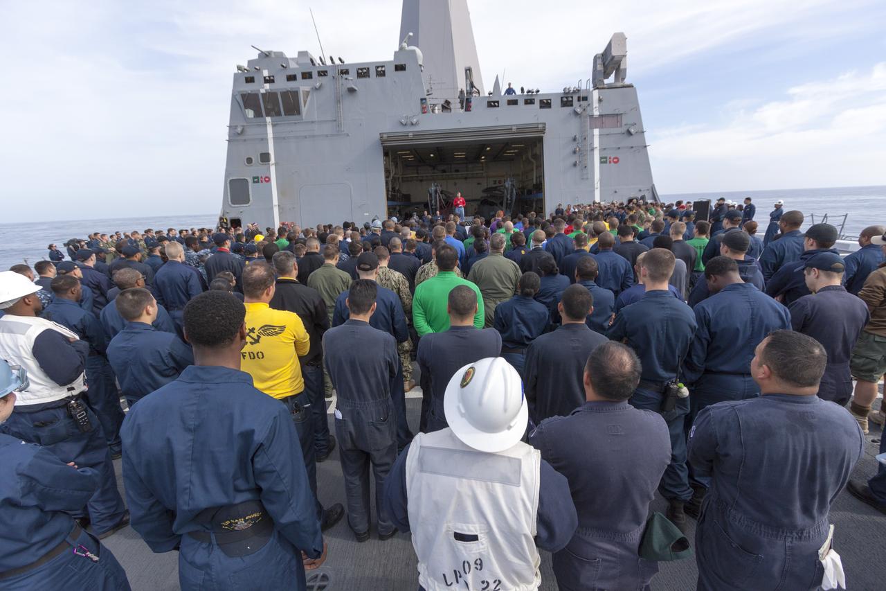 SAN DIEGO, Calif. – On the top deck of the USS San Diego, NASA and U.S. Navy personnel gather after the Orion underway recovery test. The Orion boilerplate test vehicle and other hardware were transported about 100 miles offshore for the recovery test. NASA and the U.S. Navy conducted tests to prepare for recovery of the Orion crew module, forward bay cover and parachutes on its return from a deep space mission. The underway recovery test will allow the teams to demonstrate and evaluate the recovery processes, procedures, hardware and personnel in open waters. During the testing, the tether lines were unable to support the tension caused by crew module motion that was driven by wave turbulence in the well deck of the ship. NASA and the U.S. Navy are reviewing the testing data collected to evaluate the next steps. The Ground Systems Development and Operations Program conducted the underway recovery tests. Orion is the exploration spacecraft designed to carry astronauts to destinations not yet explored by humans, including an asteroid and Mars. It will have emergency abort capability, sustain the crew during space travel and provide safe re-entry from deep space return velocities. The first unpiloted test flight of the Orion is scheduled to launch in 2014 atop a Delta IV rocket and in 2017 on NASA’s Space Launch System rocket. For more information, visit http://www.nasa.gov/orion. Photo credit: NASA/Cory Huston