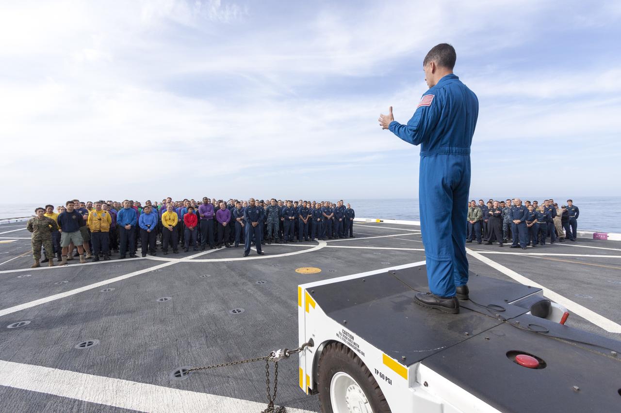 SAN DIEGO, Calif. – On the top deck of the USS San Diego, NASA and U.S. Navy personnel gather after the Orion underway recovery test. The Orion boilerplate test vehicle and other hardware were transported about 100 miles offshore for the recovery test. NASA and the U.S. Navy conducted tests to prepare for recovery of the Orion crew module, forward bay cover and parachutes on its return from a deep space mission. The underway recovery test will allow the teams to demonstrate and evaluate the recovery processes, procedures, hardware and personnel in open waters. During the testing, the tether lines were unable to support the tension caused by crew module motion that was driven by wave turbulence in the well deck of the ship. NASA and the U.S. Navy are reviewing the testing data collected to evaluate the next steps. The Ground Systems Development and Operations Program conducted the underway recovery tests. Orion is the exploration spacecraft designed to carry astronauts to destinations not yet explored by humans, including an asteroid and Mars. It will have emergency abort capability, sustain the crew during space travel and provide safe re-entry from deep space return velocities. The first unpiloted test flight of the Orion is scheduled to launch in 2014 atop a Delta IV rocket and in 2017 on NASA’s Space Launch System rocket. For more information, visit http://www.nasa.gov/orion. Photo credit: NASA/Cory Huston