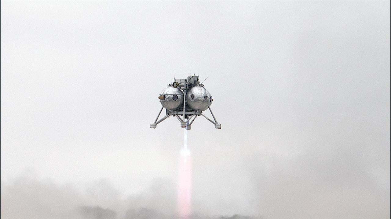 CAPE CANAVERAL, Fla. – The Project Morpheus prototype lander ascends on its sixth free flight test at the north end of the Shuttle Landing Facility at NASA’s Kennedy Space Center in Florida. The 82-second test began at 11:32 a.m. EST with the Morpheus lander launching from the ground over a flame trench and ascending to 465 feet. The lander flew forward, covering 633 feet while performing a 55-foot divert to emulate a hazard avoidance maneuver before descending and landing on a dedicated pad inside the automated landing and hazard avoidance technology, or ALHAT, hazard field. Morpheus landed 10 inches west of its intended target. Project Morpheus tests NASA’s ALHAT and an engine that runs on liquid oxygen and methane, or green propellants, into a fully-operational lander that could deliver cargo to other planetary surfaces. The landing facility provides the lander with the kind of field necessary for realistic testing, complete with rocks, craters and hazards to avoid. Morpheus’ ALHAT payload allows it to navigate to clear landing sites amidst rocks, craters and other hazards during its descent. Project Morpheus is being managed under the Advanced Exploration Systems, or AES, Division in NASA’s Human Exploration and Operations Mission Directorate. The efforts in AES pioneer new approaches for rapidly developing prototype systems, demonstrating key capabilities and validating operational concepts for future human missions beyond Earth orbit. For more information on Project Morpheus, visit http://morpheuslander.jsc.nasa.gov/. Photo credit: NASA/Frankie Martin