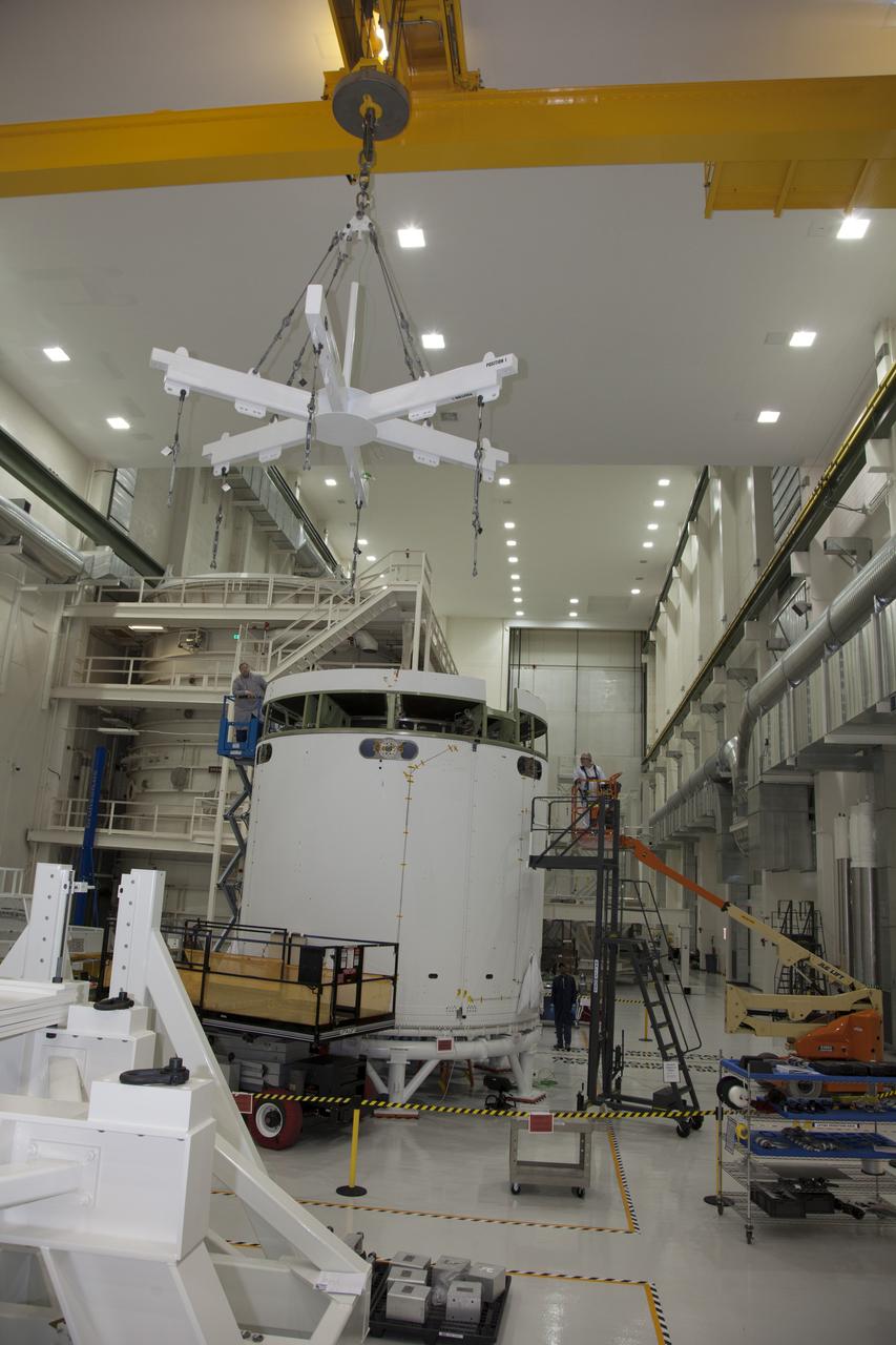 CAPE CANAVERAL, Fla. - Inside the Operations and Checkout Building high bay at NASA’s Kennedy Space Center in Florida, a crane is used to lift a ground support tool that will be used to transfer the service module for the Orion spacecraft to a static test stand. Orion is the exploration spacecraft designed to carry astronauts to destinations not yet explored by humans, including an asteroid and Mars. It will have emergency abort capability, sustain the crew during space travel and provide safe re-entry from deep space return velocities. The first unpiloted test flight of the Orion is scheduled to launch in 2014 atop a Delta IV rocket and in 2017 on NASA’s Space Launch System rocket. For more information, visit http://www.nasa.gov/orion. Photo credit: NASA/Daniel Casper