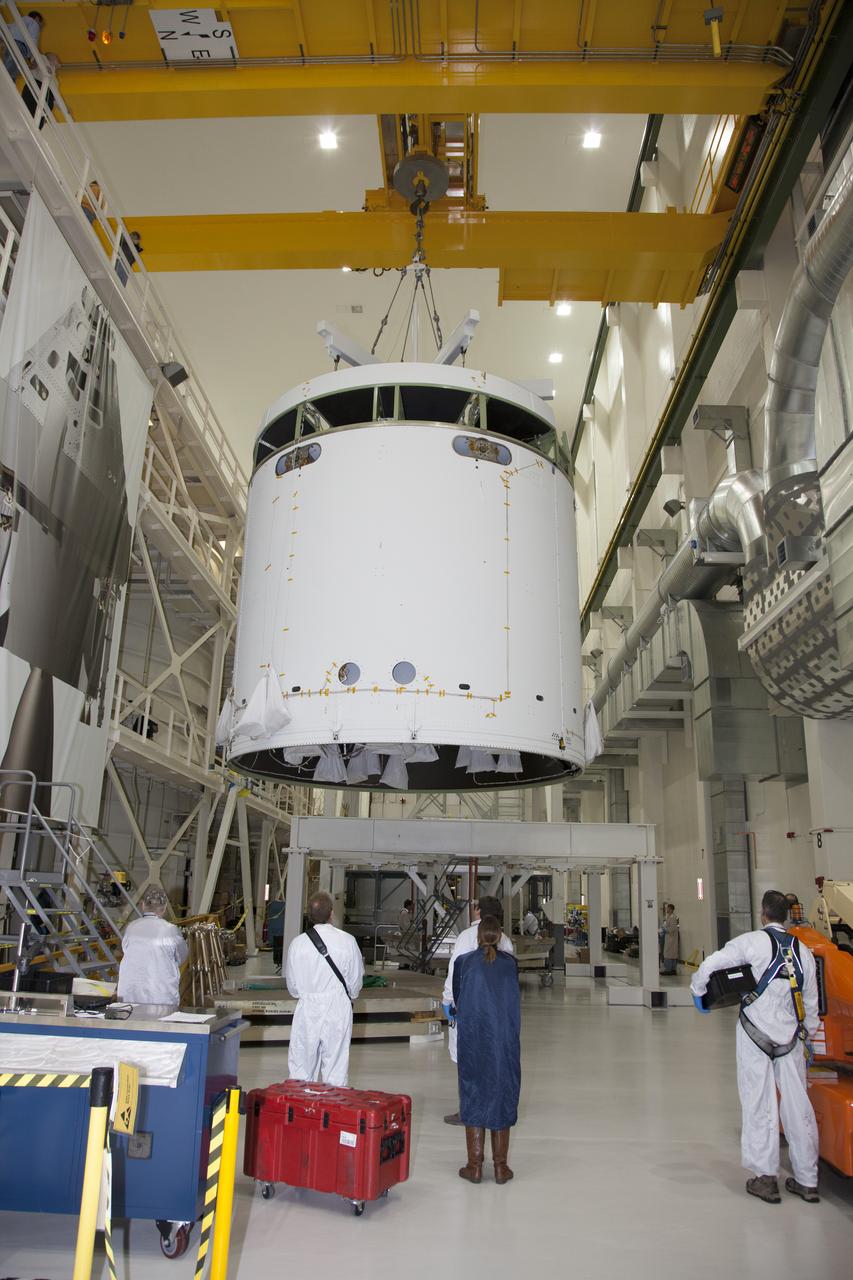 CAPE CANAVERAL, Fla. - Inside the Operations and Checkout Building high bay at NASA’s Kennedy Space Center in Florida, a ground support tool attached to a crane is used to lift the service module for the Orion spacecraft from a stand. The service module is being transferred to a static test stand. Orion is the exploration spacecraft designed to carry astronauts to destinations not yet explored by humans, including an asteroid and Mars. It will have emergency abort capability, sustain the crew during space travel and provide safe re-entry from deep space return velocities. The first unpiloted test flight of the Orion is scheduled to launch in 2014 atop a Delta IV rocket and in 2017 on NASA’s Space Launch System rocket. For more information, visit http://www.nasa.gov/orion. Photo credit: NASA/Daniel Casper