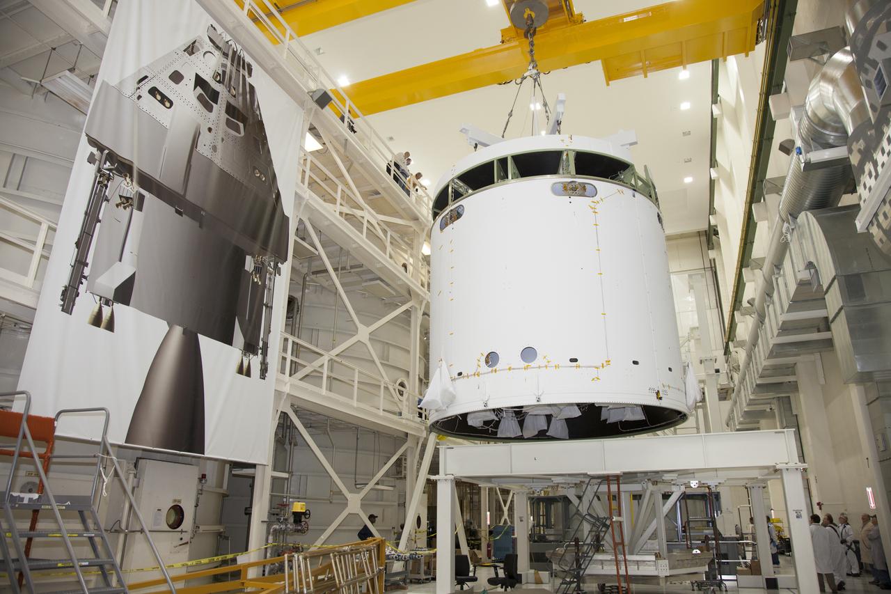 CAPE CANAVERAL, Fla. - Inside the Operations and Checkout Building high bay at NASA’s Kennedy Space Center in Florida, a ground support tool attached to a crane is used to lift the service module for the Orion spacecraft from a stand. The service module is being transferred to a static test stand. Orion is the exploration spacecraft designed to carry astronauts to destinations not yet explored by humans, including an asteroid and Mars. It will have emergency abort capability, sustain the crew during space travel and provide safe re-entry from deep space return velocities. The first unpiloted test flight of the Orion is scheduled to launch in 2014 atop a Delta IV rocket and in 2017 on NASA’s Space Launch System rocket. For more information, visit http://www.nasa.gov/orion. Photo credit: NASA/Daniel Casper