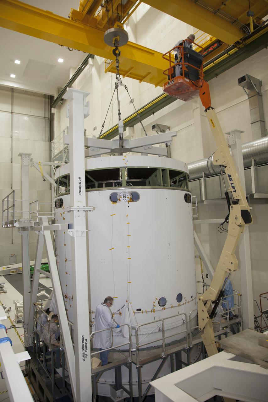 CAPE CANAVERAL, Fla. - Inside the Operations and Checkout Building high bay at NASA’s Kennedy Space Center in Florida, technicians on a platform monitor the progress as a crane lowers the service module for the Orion spacecraft onto a static test stand. Orion is the exploration spacecraft designed to carry astronauts to destinations not yet explored by humans, including an asteroid and Mars. It will have emergency abort capability, sustain the crew during space travel and provide safe re-entry from deep space return velocities. The first unpiloted test flight of the Orion is scheduled to launch in 2014 atop a Delta IV rocket and in 2017 on NASA’s Space Launch System rocket. For more information, visit http://www.nasa.gov/orion. Photo credit: NASA/Daniel Casper  